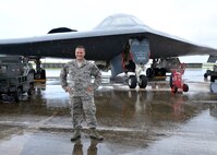 U.S. Air Force Tech Sgt. Brock Schuld, 131st Aircraft Maintenance Squadron maintainer, poses in front of a B-2 Spirit bomber during a deployment, Andersen Air Force Base, Guam, Aug. 22, 2014.  The bombers and approximately 200 support Airmen, assigned to the 509th Bomb Wing at Whiteman Air Force Base, Mo., deployed to Guam Aug. 6, 2014 to improve combat readiness and ensure regional stability.  Bomber deployments help maintain stability in the region while allowing units to become familiar with operating in the theater according to USPACOM.  (U.S. Air Force photo by Senior Airman Cierra Presentado/Released)
