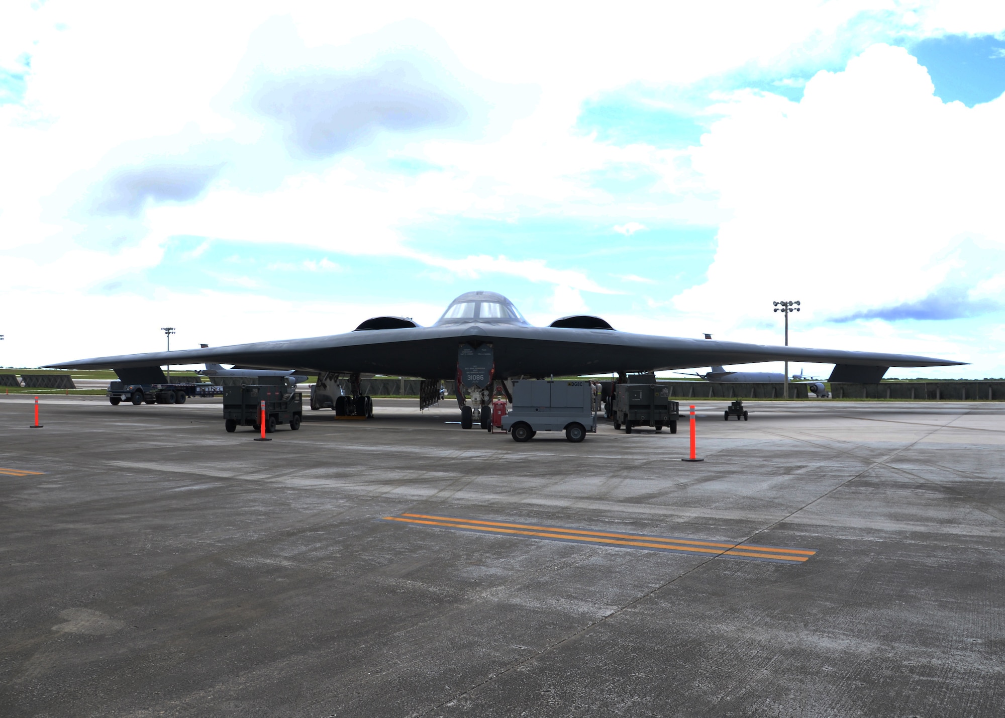 Airmen from the 509th Aircraft Maintenance Squadron work on a B-2 Spirit bomber during a deployment, Andersen Air Force Base, Guam, Aug. 22, 2014.The bombers and approximately 200 support Airmen, assigned to the 509th Bomb Wing at Whiteman Air Force Base, Mo., deployed to Guam Aug. 6, 2014 to improve combat readiness and ensure regional stability.  Bomber deployments help maintain stability in the region while allowing units to become familiar with operating in the theater according to USPACOM.  (U.S. Air Force photo by Senior Airman Cierra Presentado/Released)