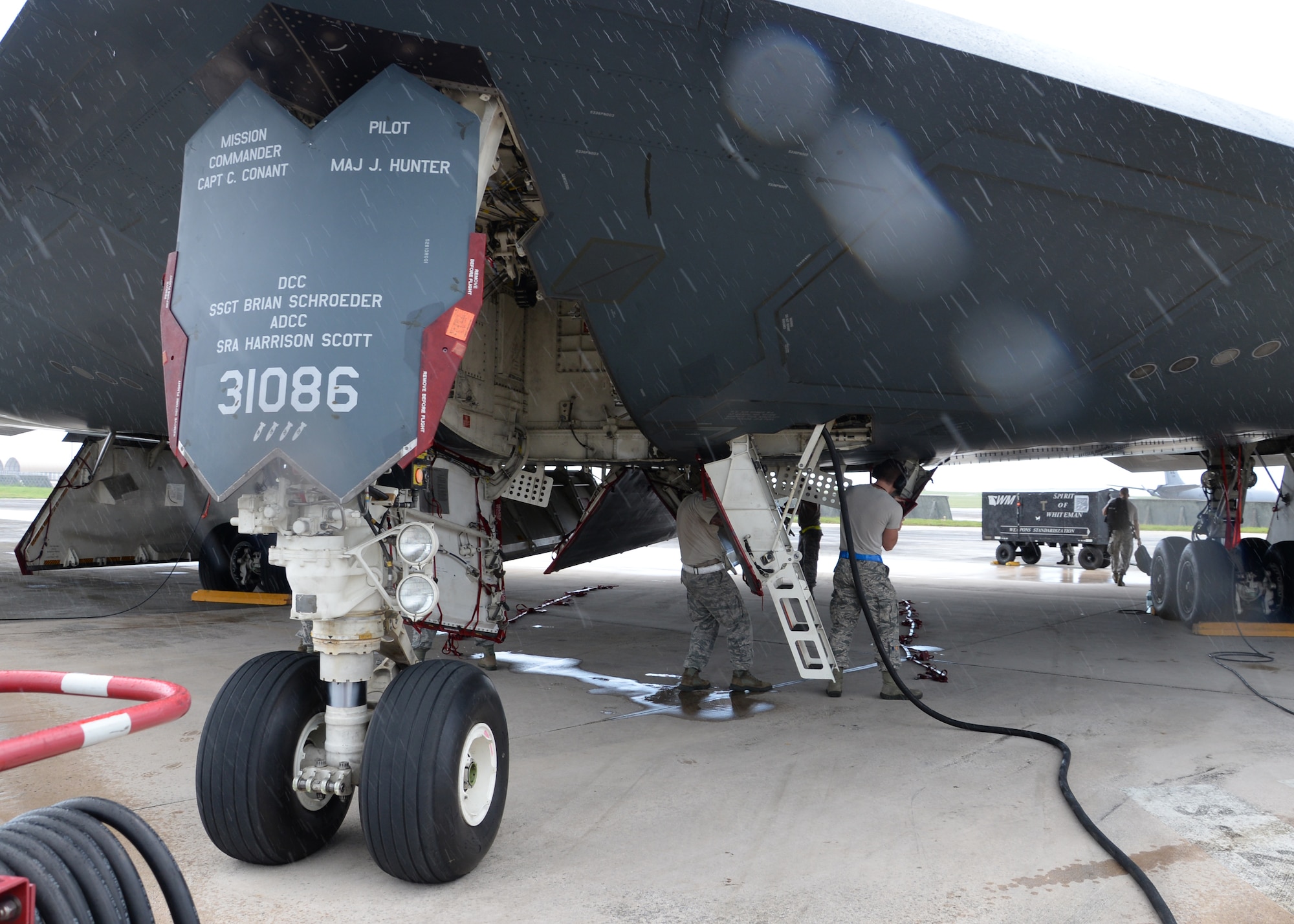 Airmen from the 509th Aircraft Maintenance Squadron work on a B-2 Spirit bomber during a deployment, Andersen Air Force Base, Guam, Aug. 22, 2014.The bombers and approximately 200 support Airmen, assigned to the 509th Bomb Wing at Whiteman Air Force Base, Mo., deployed to Guam Aug. 6, 2014 to improve combat readiness and ensure regional stability.  Bomber deployments help maintain stability in the region while allowing units to become familiar with operating in the theater according to USPACOM.  (U.S. Air Force photo by Senior Airman Cierra Presentado/Released)