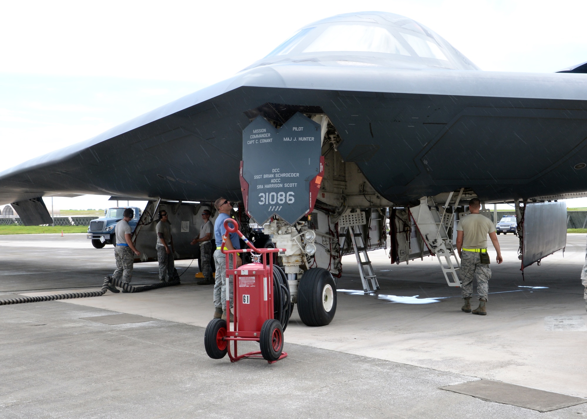 Airmen from the 509th Aircraft Maintenance Squadron work on a B-2 Spirit bomber during a deployment, Andersen Air Force Base, Guam, Aug. 22, 2014.The bombers and approximately 200 support Airmen, assigned to the 509th Bomb Wing at Whiteman Air Force Base, Mo., deployed to Guam Aug. 6, 2014 to improve combat readiness and ensure regional stability.  Bomber deployments help maintain stability in the region while allowing units to become familiar with operating in the theater according to USPACOM.  (U.S. Air Force photo by Senior Airman Cierra Presentado/Released)