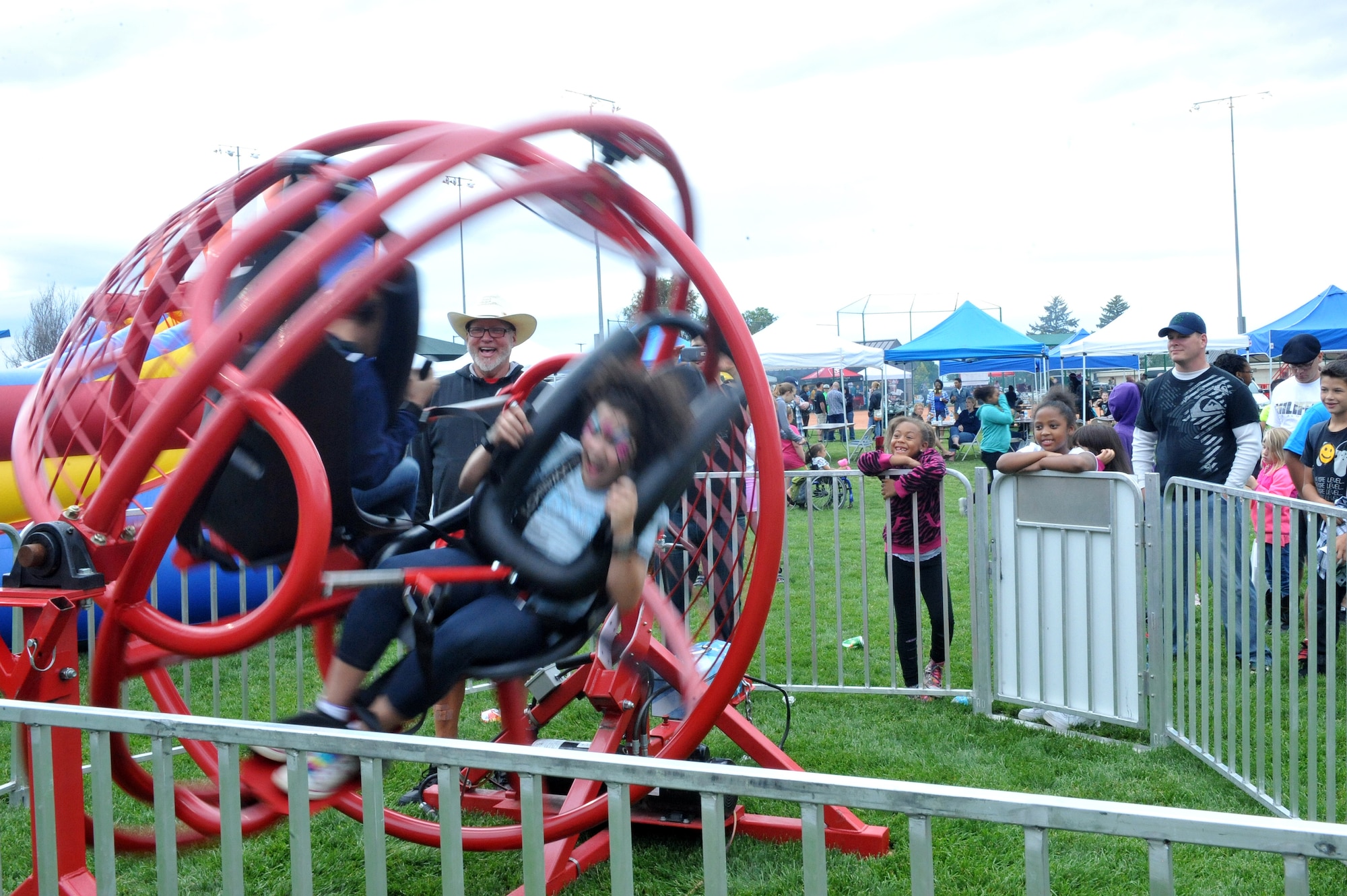 Members of Team Buckley enjoy fair rides during FunFest Aug. 22, 2014, at the softball fields on Buckley Air Force Base, Colo. The 460th Space Wing celebrated its 10th birthday with FunFest, a day filled with sport competitions and a community fair. (U.S. Air Force photo by Airman Emily E. Amyotte/Released)