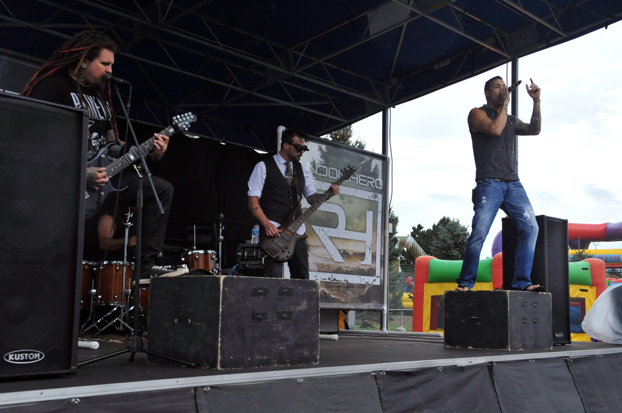 Local band Random Hero performs in front of a crowd during FunFest Aug. 22, 2014, at the softball fields on Buckley Air Force Base, Colo. The 460th Space Wing celebrated its 10th birthday with FunFest, a day filled with sport competitions and a community fair. (U.S. Air Force photo by Airman Emily E. Amyotte/Released)