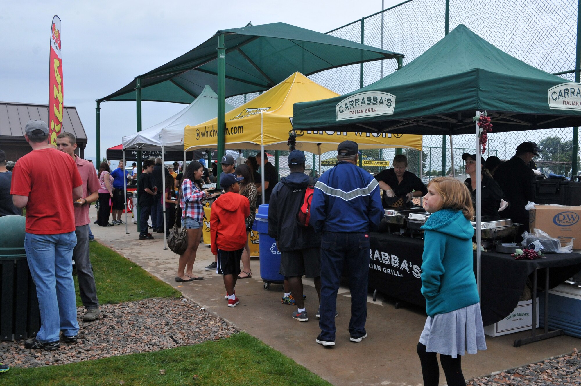 Members of Team Buckley enjoy food and activities during FunFest Aug. 22, 2014, at the softball fields on Buckley Air Force Base, Colo. The 460th Space Wing celebrated its 10th birthday with FunFest, a day filled with sport competitions and a community fair. (U.S. Air Force photo by Airman Emily E. Amyotte/Released)