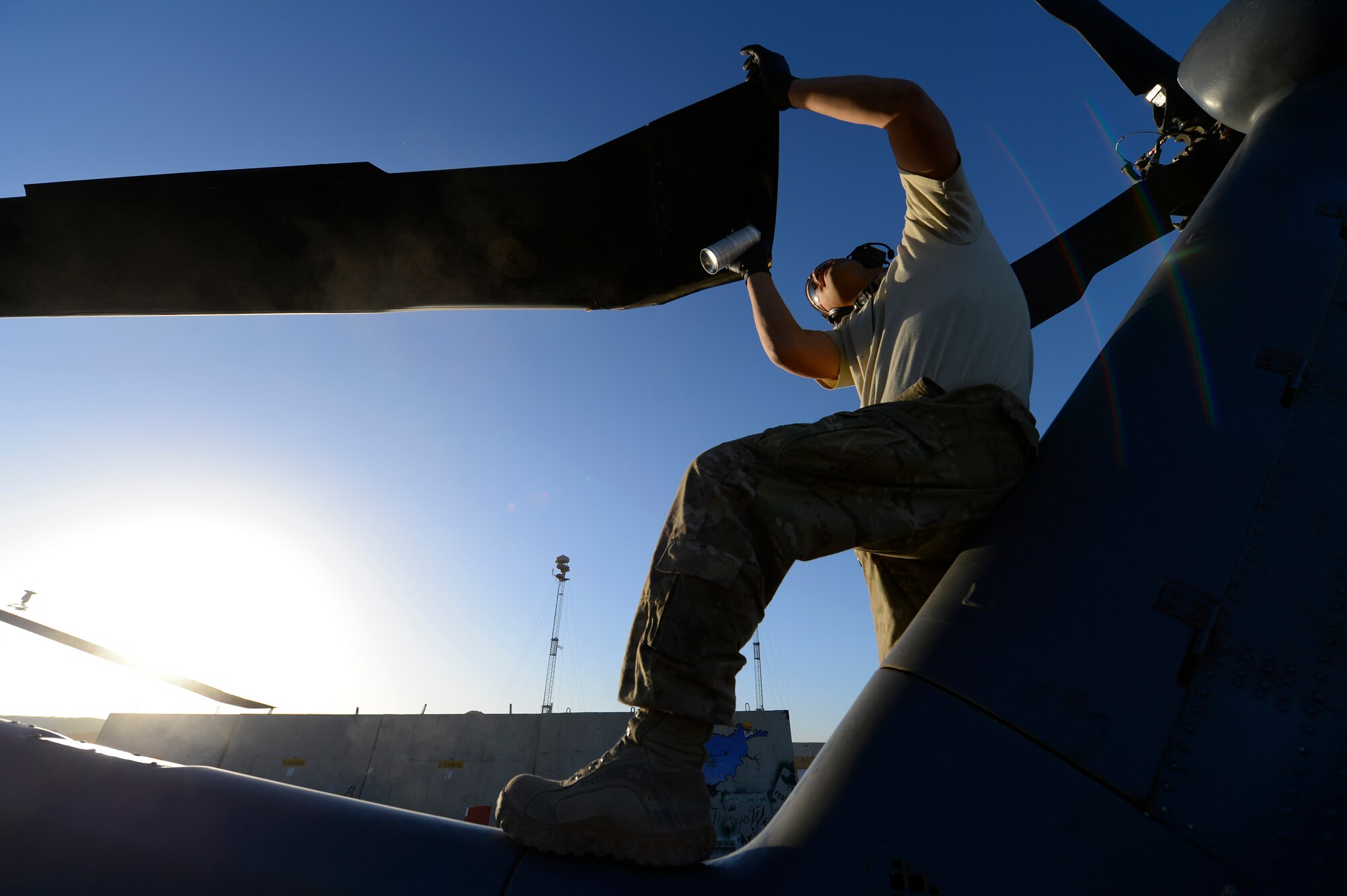 U.S. Air Force Staff Sgt. Richard Eady, 455th Expeditionary Aircraft Maintenance Squadron crew chief, conducts a preflight inspection on a HH-60G Pave Hawk at Bagram Air Field, Afghanistan, July 19, 2014. These inspections are conducted every 72 hours. Eady is a Pittsburgh, Pa., native deployed from the 923rd Aircraft Maintenance Squadron, Davis-Monthan Air Force Base, Ariz. (U.S. Air Force photo by Senior Airman Sandra Welch)