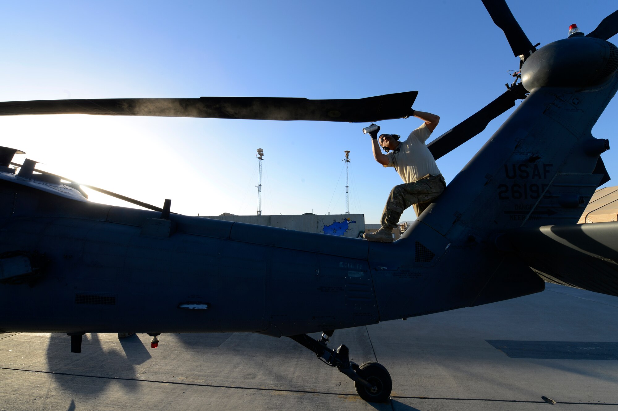 U.S. Air Force Staff Sgt. Richard Eady, 455th Expeditionary Aircraft Maintenance Squadron crew chief, conducts a preflight inspection on a HH-60G Pave Hawk at Bagram Air Field, Afghanistan, July 19, 2014. These inspections are conducted every 72 hours. Eady is a Pittsburgh, Pa., native deployed from the 923rd Aircraft Maintenance Squadron, Davis-Monthan Air Force Base, Ariz. (U.S. Air Force photo by Senior Airman Sandra Welch)