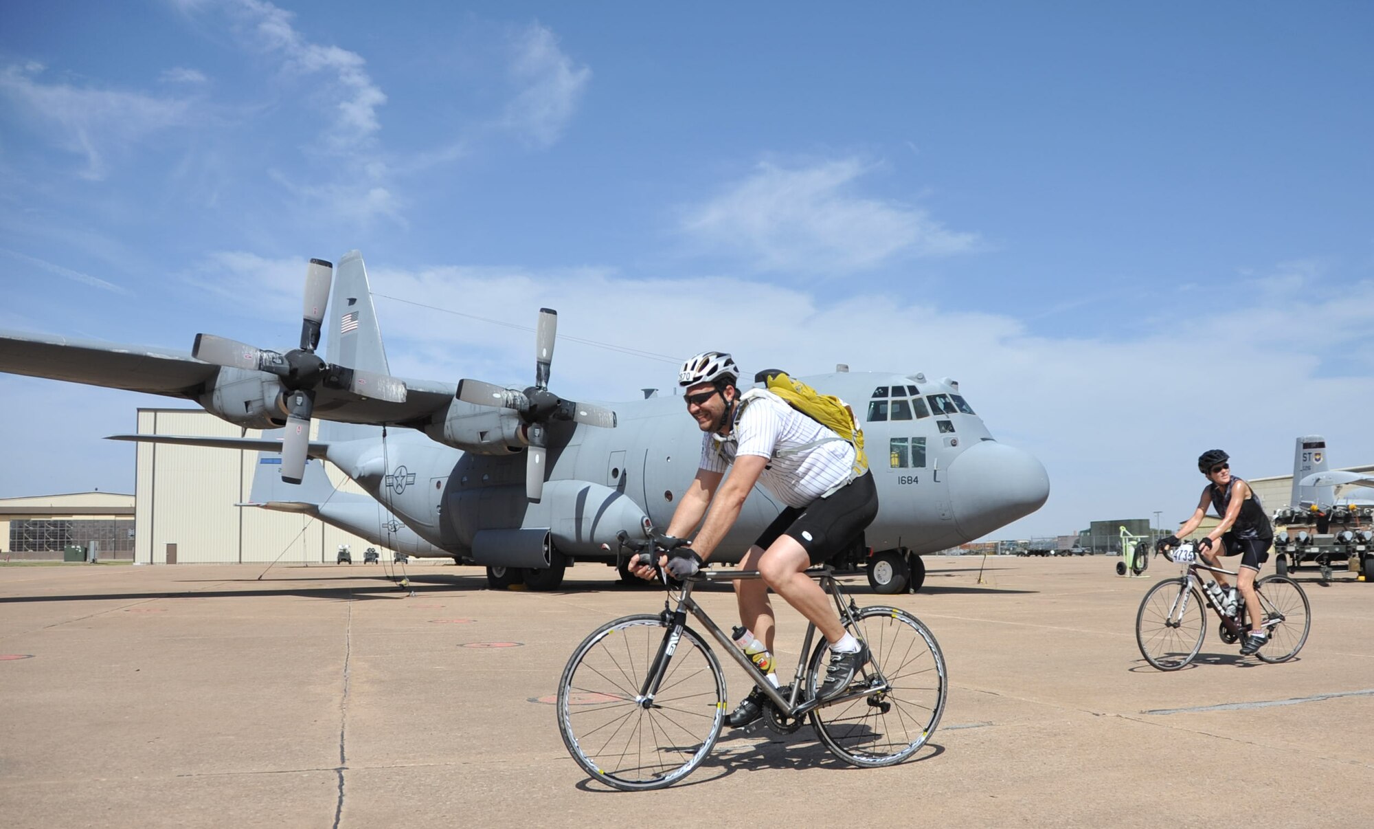 Hotter’N Hell participants cruise through Airpower Alley on Sheppard Air Force Base, Texas, Aug. 23, 2014. Cyclists competing in the Hotter’N Hell bike race passes through Airpower Alley where riders had the opportunity to meet and greet Air Force pilots and take pictures with several different aircraft. (U.S. Air Force photo/Airman 1st Class Robert L. McIlrath)