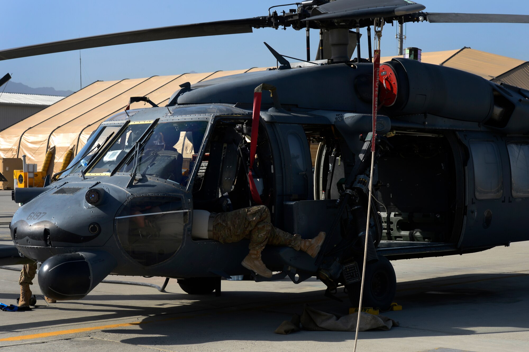 Airmen from the 455th Expeditionary Aircraft Maintenance Squadron conduct a preflight inspection on an HH-60G Pave Hawk helicopter at Bagram Air Field, Afghanistan, July 10, 2014. The maintenance team is deployed from the 923rd Aircraft Maintenance Squadron, Davis-Monthan Air Force Base, Arizona. (U.S. Air Force photo by Senior Airman Sandra Welch/Released)