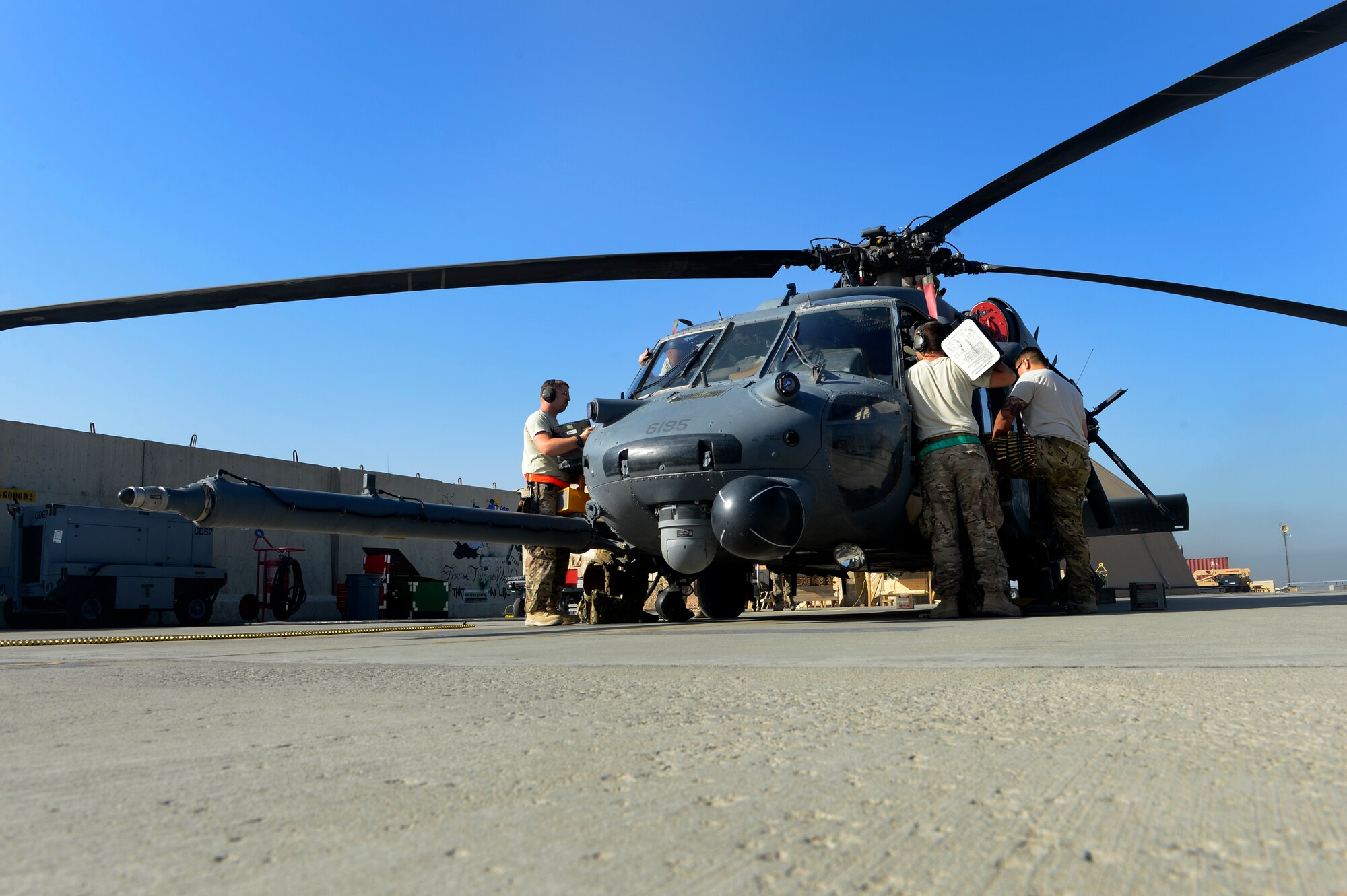 Airmen from the 455th Expeditionary Aircraft Maintenance Squadron conduct a pre-flight inspection on an HH-60G Pave Hawk helicopter at Bagram Air Field, Afghanistan, July 10, 2014. The maintenance team is deployed from the 923rd Aircraft Maintenance Squadron, Davis-Monthan Air Force Base, Arizona. (U.S. Air Force photo by Senior Airman Sandra Welch/Released)