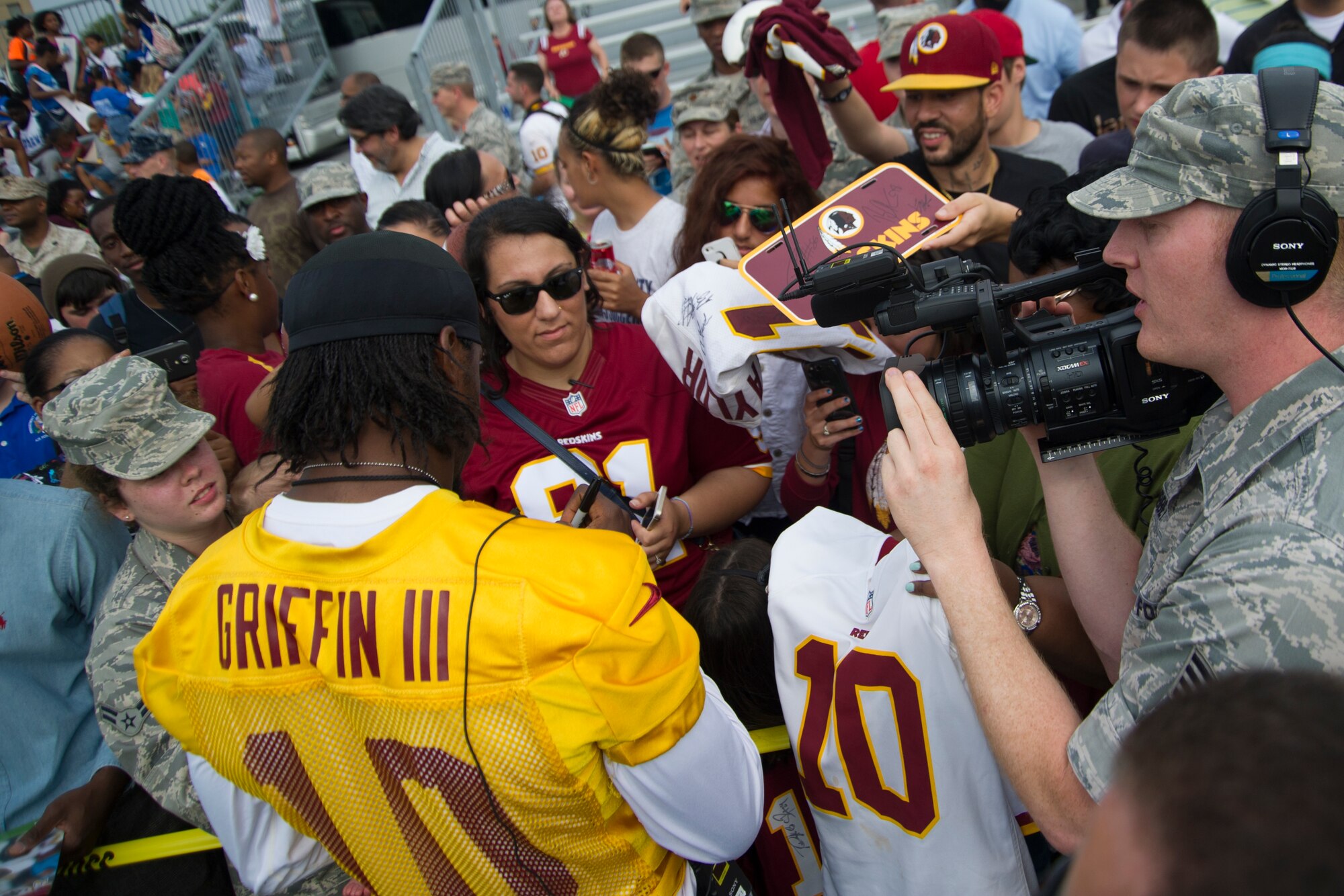 Washington Redskins quarterback Robert Griffin III signs autographs for fans after a walk-through practice at Joint Base Andrews August 22,2014. The team conducted the practice and signed autographs for military members and their families here as part of their Redskins Salute effort. (U.S. Air Force photo/Staff Sgt. Robert Cloys)