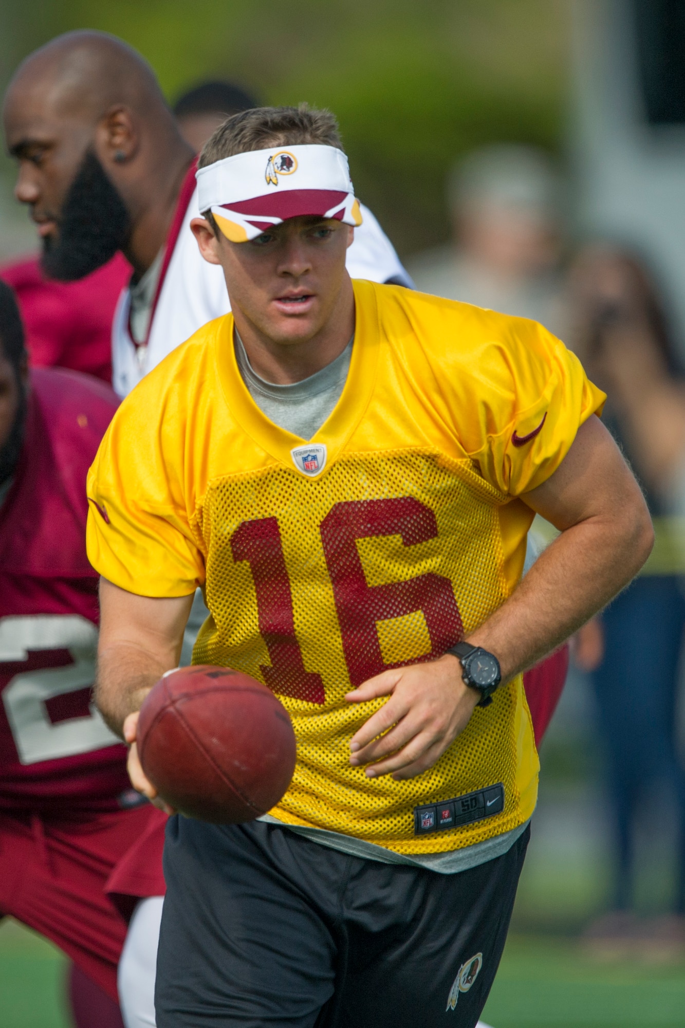 Washington Redskins quarterback Colt McCoy prepares to hand off the football during a walk-through practice at Joint Base Andrews August 22,2014. The team conducted the practice and signed autographs for military members and their families here as part of their Redskins Salute effort. (U.S. Air Force photo/Staff Sgt. Robert Cloys)