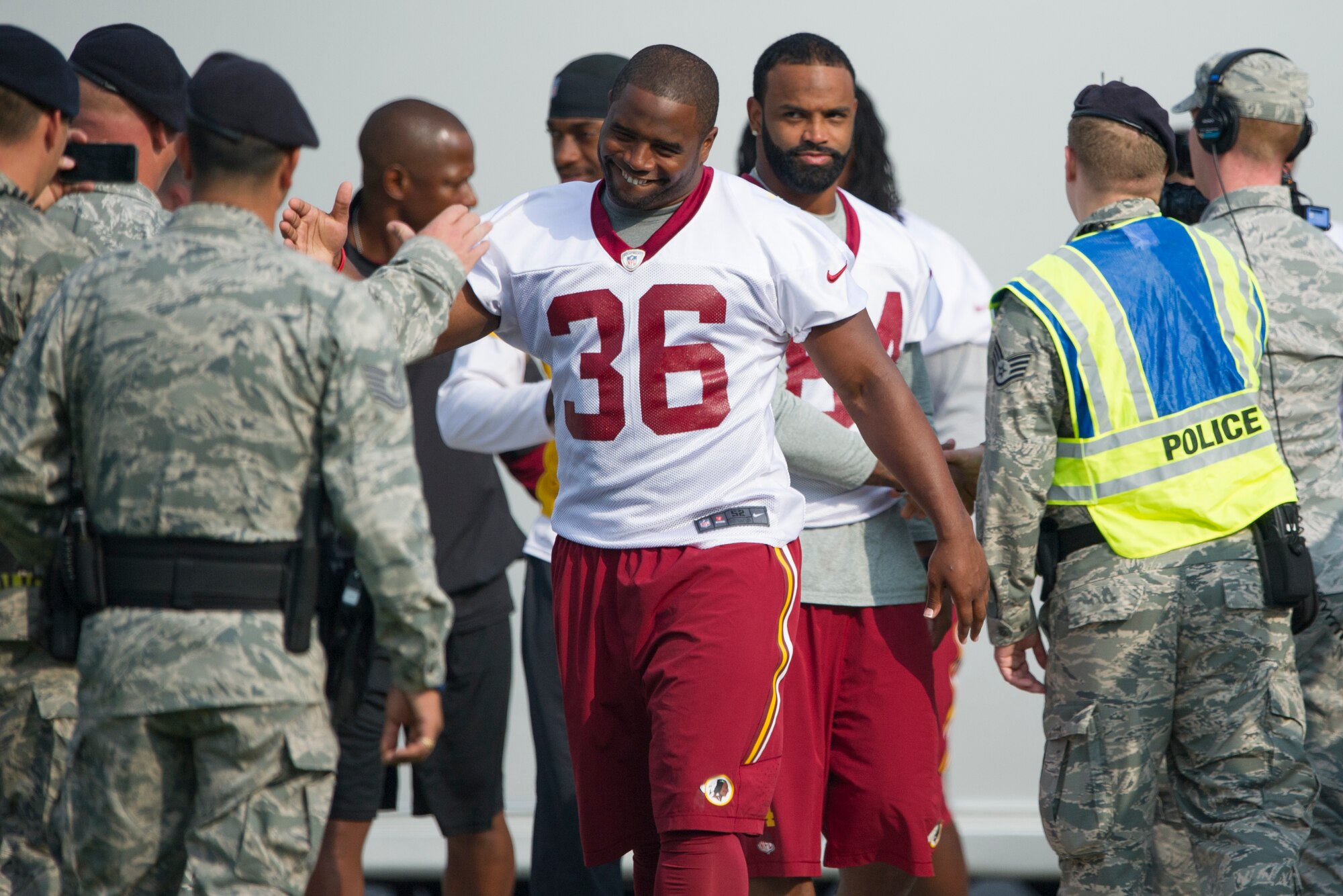 Washington Redskins fullback Darrel Young greats a security forces member after arriving at Joint Base Andrews August 22,2014. The team performed a walk-through practice and signed autographs for military members and their families as part of their Redskins Salute effort. (U.S. Air Force photo/Staff Sgt. Robert Cloys)