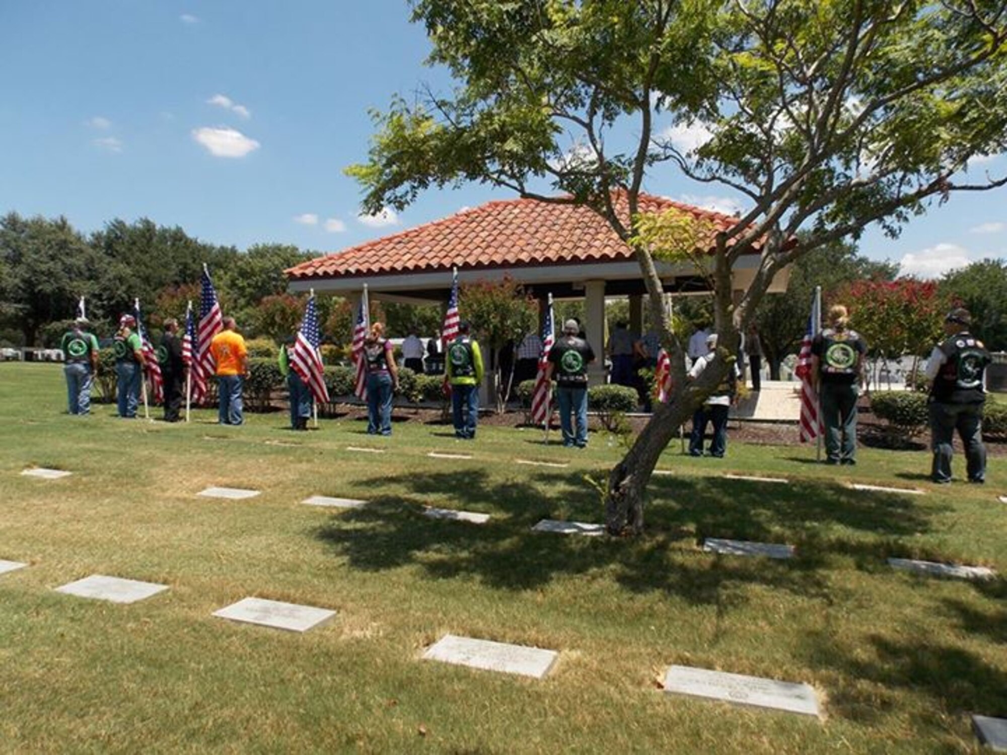 Members of the Green knights hold flags at  funeral in San Antonio, Texas, Aug. 8, 2014. The Green Knights are an international military motorcyle club and members from several Texas chapters escorted the remains of veteran Clyde Slonaker. (Courtesy photo)