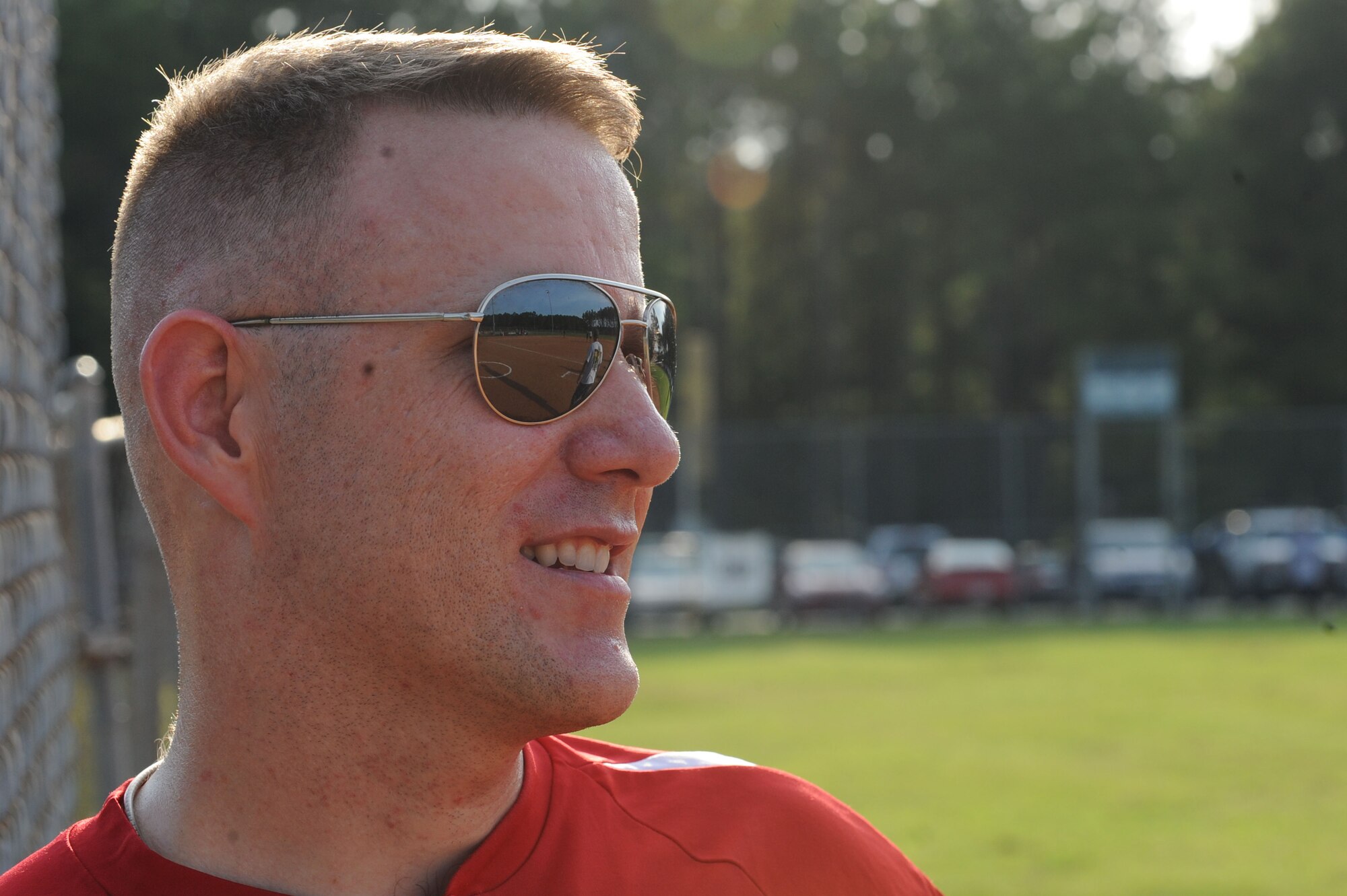 U.S. Air Force Master Sgt. Nicholas Cataldi, 20th Fighter Wing chapel superintendent, watches the Rising IV softball team play against the Shaw 5/6 team at Shaw Air Force Base, S.C., Aug. 21, 2014. Shaw AFB hosted a family fun night which featured softball games, bouncy castles, music, and food. (U.S. Air Force photo by Airman 1st Class Michael Cossaboom/Released)