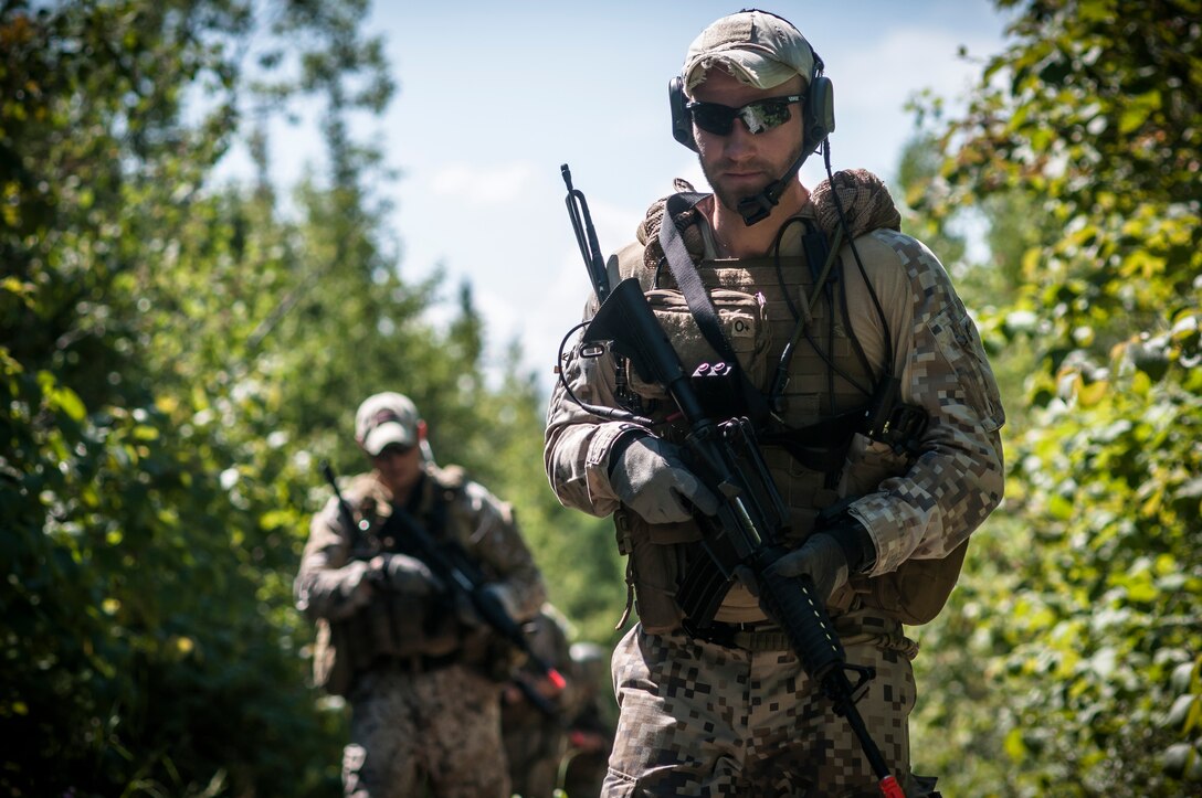 Capt. Armands Rutkis from the Latvian Armed Forces walks in formation while on a close air support mission during Operation Northern Strike 2014 near Rogers City, Mich. on Aug. 5, 2014. Operation Northern Strike 2014 is a joint multi-national combined arms training exercise conducted in Michigan. (U.S. Air National Guard photo by Master Sgt. Scott Thompson/released)