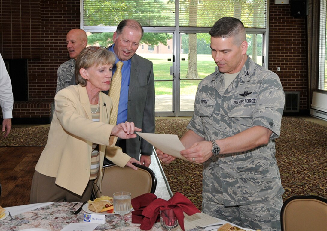 Amy Foster (left at table), the director of the Arnold Engineering Development Complex (AEDC) Contracting Execution Division, speaks to AEDC Commander Raymond Toth (right at table) at the Women’s Equality Day Luncheon on Aug. 6, about the women who were part of “The First” list that was available at each luncheon table. The list contained names of women who achieved first accomplishments in the nation’s history. Foster, who was listed among “The First” women, also addressed the luncheon attendees with a speech titled “Be the One.” Foster is the first Air Force female civilian at AEDC to be appointed as a two-letter director. (Photo by Jacqueline Cowan) 