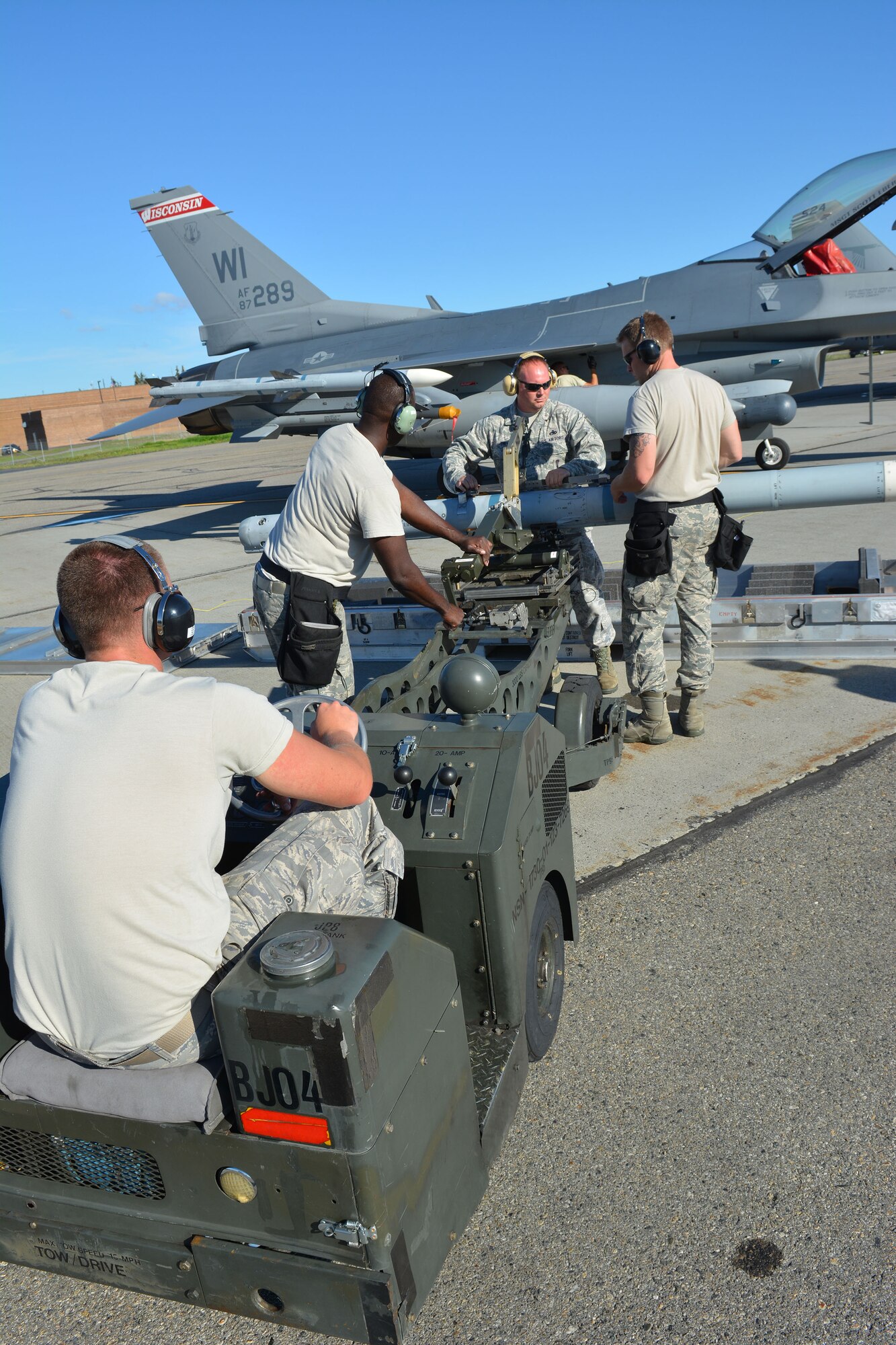Airmen prepare to load an F-16 Fighting Falcon from the 115th Fighter Wing in Madison, Wis., during the RED FLAG-Alaska exercise at Eielson Air Force Base, Alaska, Aug. 12, 2014. Approximately 130 Airmen from the 115 FW participated in the event, refreshing skills and working in real-world scenarios to test their combat abilities in a high-paced environment. (Air National Guard photo by Staff Sgt. Ryan Roth)