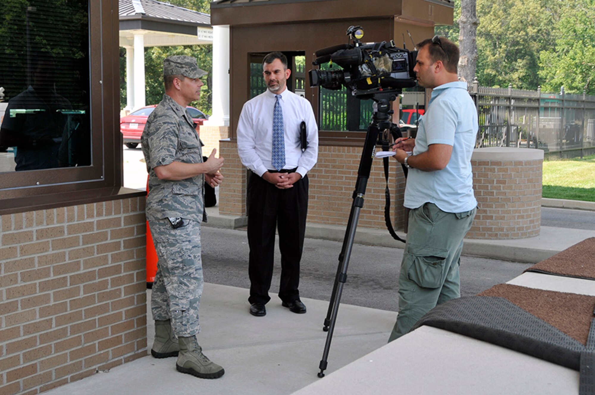 Arnold Engineering Development Complex (AEDC) Commander Col. Raymond Toth, left, speaks with a reporter from Channel 4 News after the mock press conference held as part of the active shooter drill that took place at Arnold Air Force Base on Aug. 4. Pictured center is Jason Austin, chief of AEDC Public Affairs. (Photo by Jacqueline Cowan)