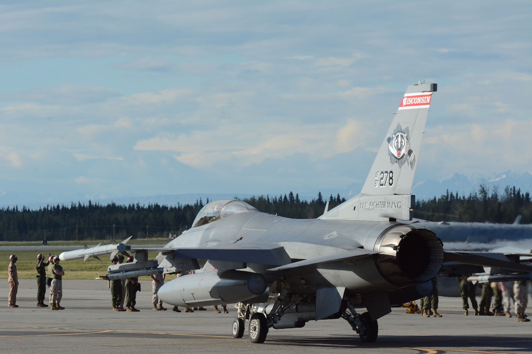Airmen surround an F-16 Fighting Falcon from the 115th Fighter Wing in Madison, Wis., during the RED FLAG-Alaska exercise at Eielson Air Force Base, Alaska, Aug. 11, 2014. Approximately 130 Airmen from the 115 FW participated in the event, refreshing skills and working in real-world scenarios to test their combat abilities in a high-paced environment. (Air National Guard photo by Staff Sgt. Ryan Roth)