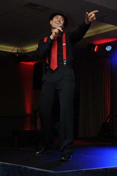 Master Sgt. Agustin Pascual from the 319th Force Support Squadron sings ?Valerie? by Bruno Mars during the AMC Icon singing competition at the Northern Lights Club on Grand Forks Air Force Base, Aug. 22, 2014. Fifteen contestants competed for the opportunity to represent the base at the main AMC Icon event at Scott AFB, Ill., and a possible spot in the Air Force entertainment troupe Tops in Blue. (U.S. Air Force photo/Staff Sgt. David Dobrydney)