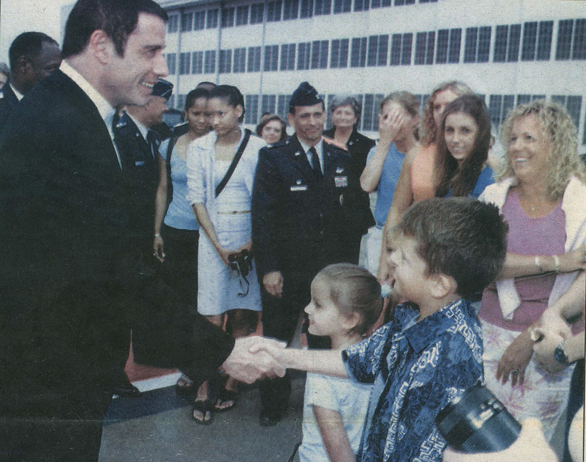 DAYTON, Ohio -- Actor John Travolta also visited in 2003. He had flown his Boeing 707 aircraft to Dayton to accept the AIAA Foundation Award for Excellence. In this Skywrighter photo, the actor is greeted at Wright-Patterson Air Force Base. (Skywrighter photo)