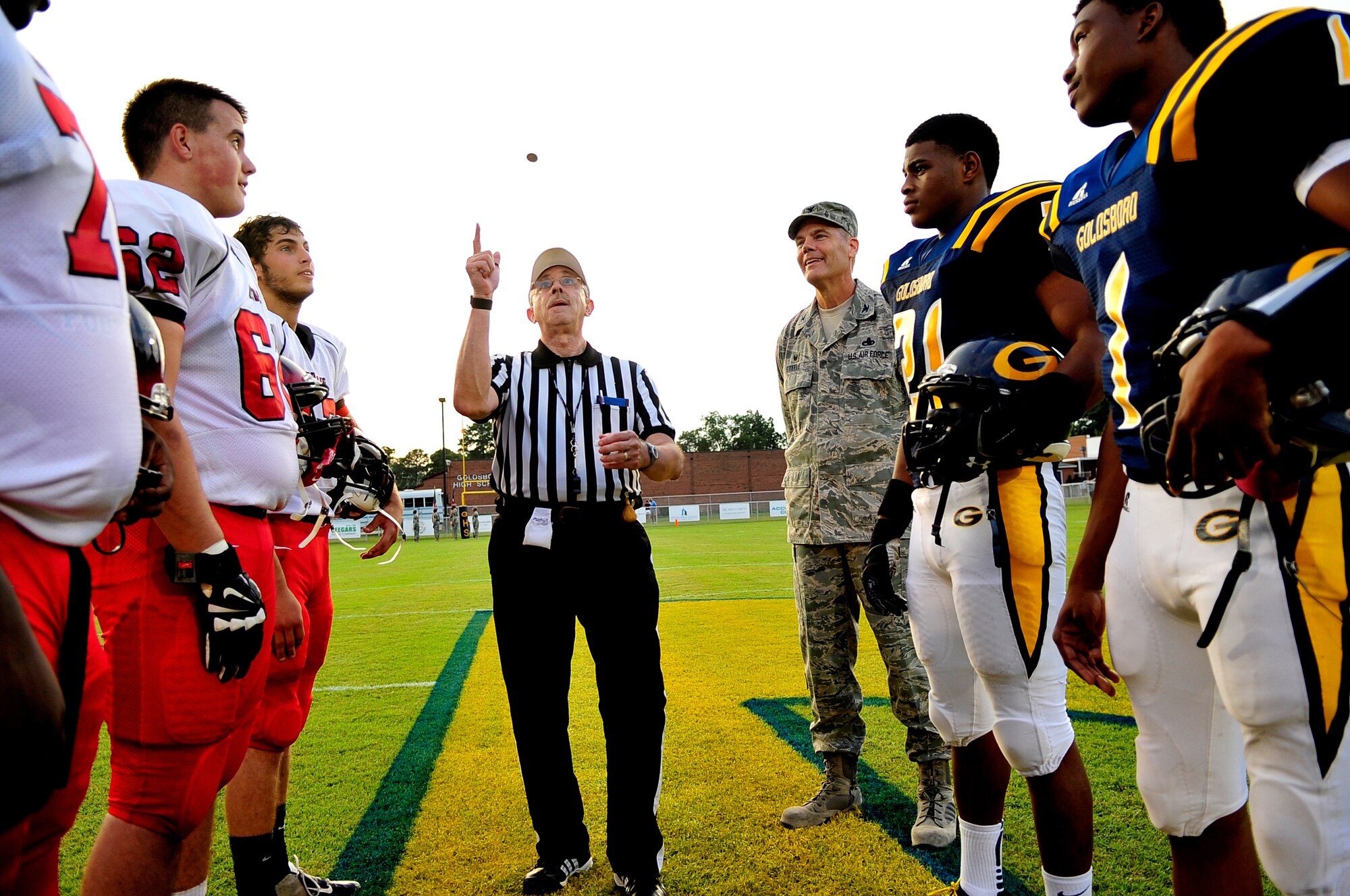 Col. Darrell Steele, 4th Maintenance Group commander, looks on during the coin toss of the Goldsboro vs. Franklinton football game Aug. 22 in Goldsboro, North Carolina. Steele presented the coin to the referee, Steve Smith, prior to the toss, and gave a pre-game speech to the Goldsboro players. (U.S. Air Force photo/Airman 1st Class Shawna L. Keyes)