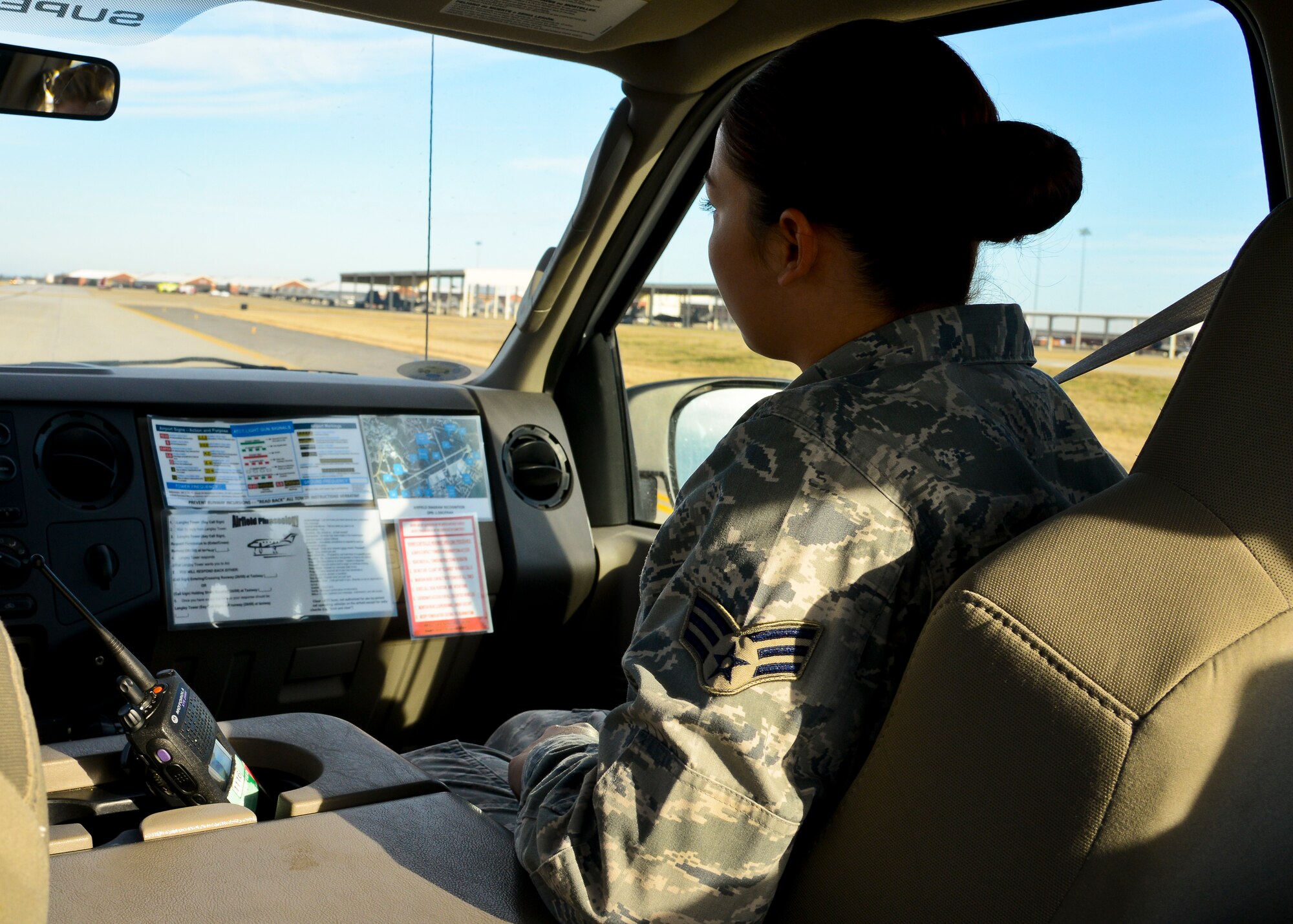 U.S. Air Force Senior Airman Erika Saldana, 1st Operations Support Squadron Airfield Management shift lead, performs the daily inspection of the flightline at Langley Air Force Base, Va., Dec. 17, 2013. Airfield management specializes in ensuring a safe, efficient and effective airfield environment by performing inspections and responding to in-flight and ground emergencies.  Saldana hails from Tulia, TX. (U.S. Air Force photo by Airman 1st Class Victoria H. Taylor/ Released)