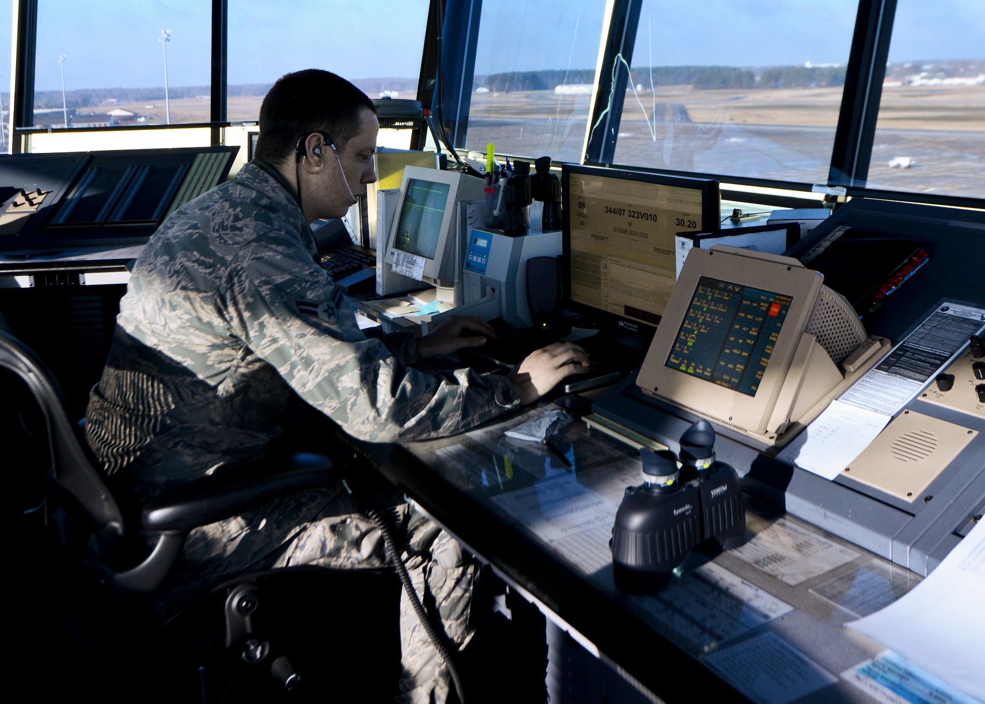 U.S. Air Force Airman 1st Class David Velke, 1st Operations Support Squadron air traffic controller, coordinates aircraft taxi movement at Langley Air Force Base, Va., Dec. 18, 2013. Air traffic controllers offer emergency assistance to aircraft and are responsible for notifying and coordinating with emergency personnel.  Velke hails from (U.S. Air Force photo by Airman 1st Class Victoria H. Taylor/ Released)
