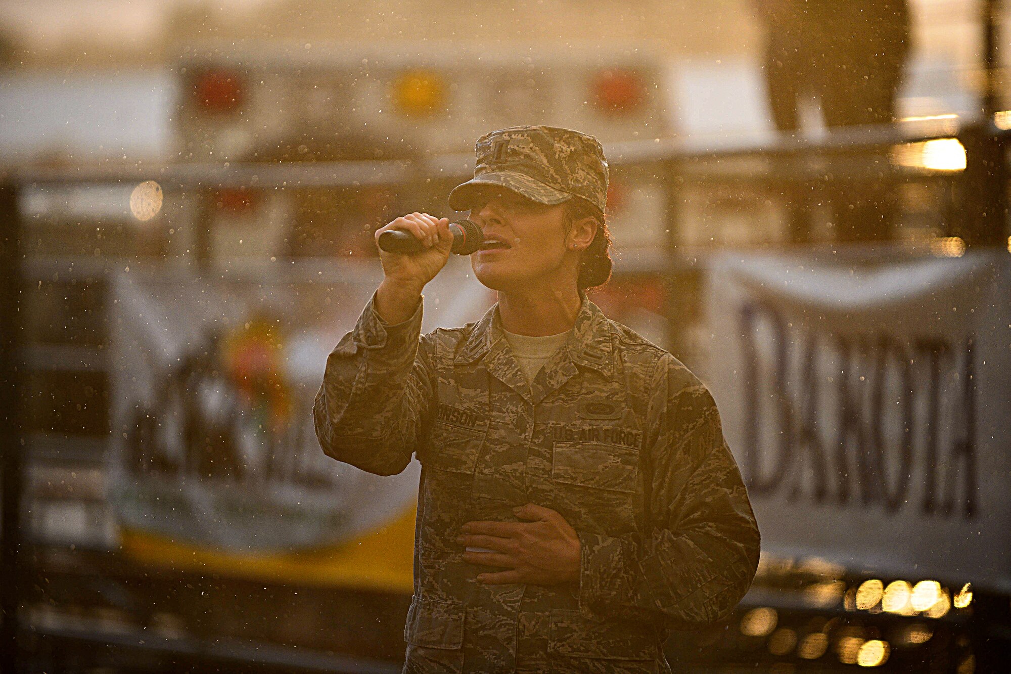 U.S. Air Force 1st Lt. Lindsay Bronson, 28th Operations Support Squadron intelligence officer, sings the national anthem during the Central States Fair Military Appreciation Night at the Central States Fairgrounds in Rapid City, S.D., Aug. 21, 2014. Hosted by the Central States Fair and Rapid City Area Chamber of Commerce Military Affairs Committee, the event was established to honor military members for their service. (U.S. Air Force photo by Senior Airman Zachary Hada/Released) 