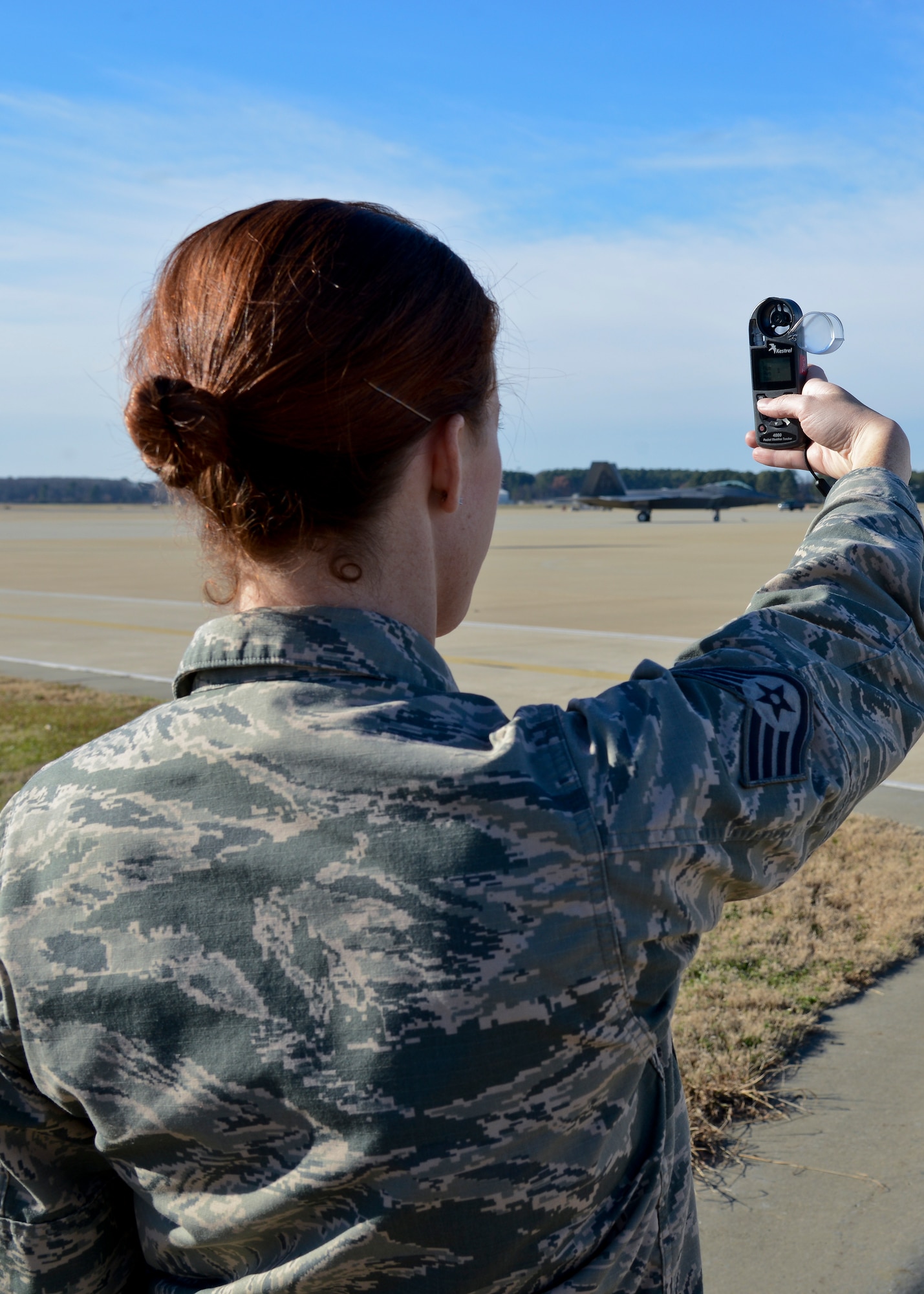 U.S. Air Force Staff Sgt. Anna Dampare, 1st Operations Support Squadron Weather Operations forecaster, uses a Kestrel at Langley Air Force Base, Va., Dec. 17, 2013. The Kestrel is a handheld weather machine that measures air pressure, wind speed and other weather factors in only four minutes. Dampare hails from Fairmont, West Virginia. (U.S. Air Force photo by Airman 1st Class Victoria H. Taylor/ Released)