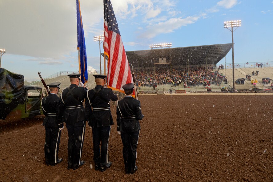 Members of the Ellsworth Air Force Base Honor Guard present the colors during an opening ceremony for the Central States Fair Military Appreciation Night at the Central States Fairgrounds in Rapid City, S.D., Aug. 21, 2014. The event allowed Ellsworth’s community partners to honor the military for their service. (U.S. Air Force photo by Senior Airman Zachary Hada/Released)