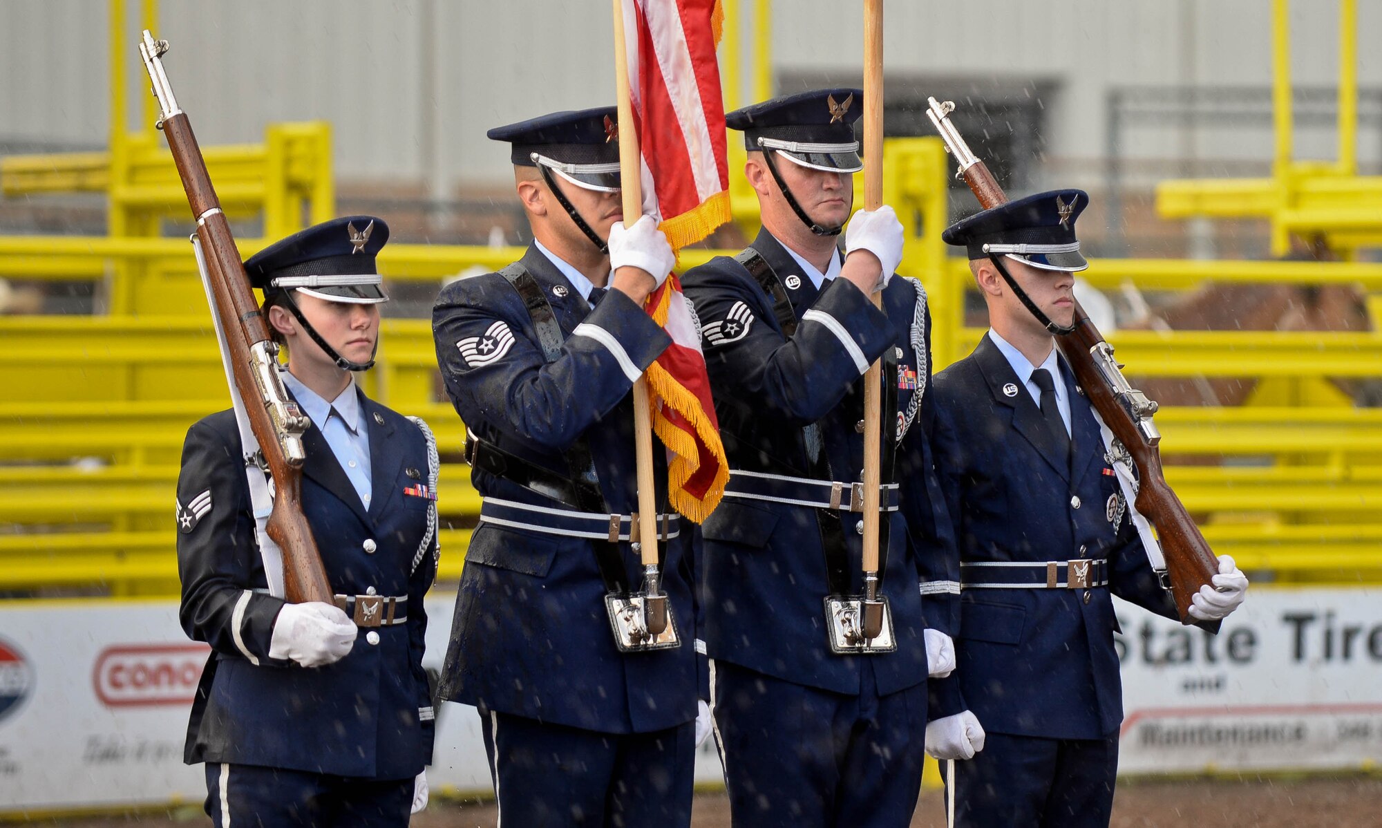Ellsworth Honor Guard members stand ready to present the colors during the Central States Fair Military Appreciation Night at the Central States Fairgrounds in Rapid City, S.D., Aug. 21, 2014. The Ellsworth Air Force Base Honor Guard is responsible for providing military honors throughout more than 114,000-square miles, covering South Dakota, western Nebraska and northern Wyoming. (U.S. Air Force photo by Senior Airman Zachary Hada/Released)