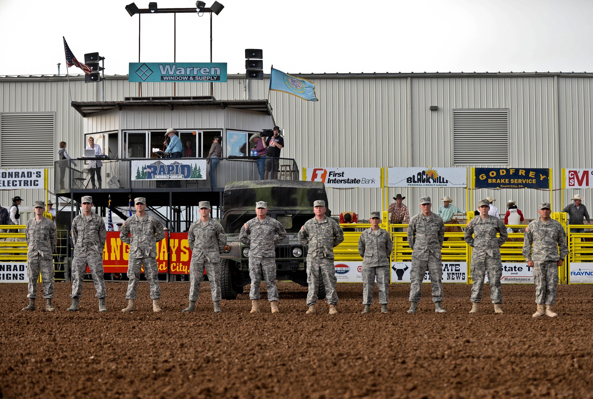 Airmen from Ellsworth Air Force Base and members of the South Dakota National Guard stand to be recognized during the Central States Fair Military Appreciation Night at the Central States Fairgrounds in Rapid City, S.D., Aug. 21, 2014. Five Ellsworth Airmen and five guardsmen were recognized for their service during the event. (U.S. Air Force photo by Senior Airman Zachary Hada/Released)