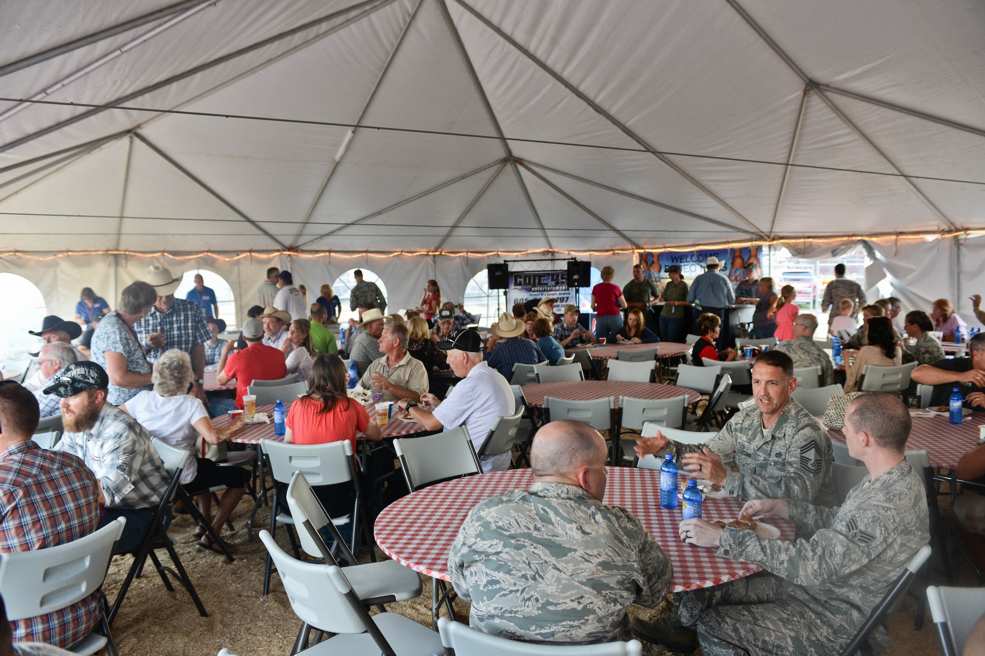 Ellsworth Airmen, South Dakota National Guard soldiers, families and friends enjoy food and festivities during the Central States Fair Military Appreciation Night at the Central States Fairgrounds in Rapid City, S.D., Aug. 21, 2014. Hosted by the Central States Fair and Rapid City Area Chamber of Commerce Military Affairs Committee, the event was established to honor military members for their service. (U.S. Air Force photo by Senior Airman Zachary Hada/Released) 