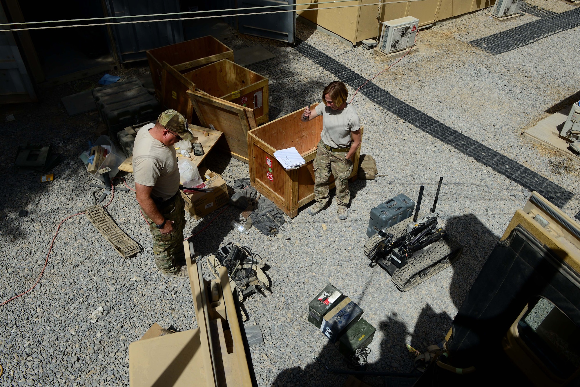 (From left) U.S. Air Force Master Sgt. Phillip Hauser and Tech Sgt. Sgt. Stacy Trosine, 466th Operating Location Bravo Explosive Ordnance Disposal flight logistics management non-commissioned officers-in-charge, inventory equipment at Kandahar Airfield, Afghanistan Aug. 18, 2014.  Since the inception of the 466th Operating Location Bravo EOD flight in 2004, there have been twenty rotations of more than 600 EOD technicians who have left their mark in the history of Operation Enduring Freedom.   Hauser is deployed from Malmstrom Air Force Base, Mont. and a native of Salina, Kan. Trosine is deployed from Fairchild Air Force Base, Wash. and a native of Colbert, Wash.  (U.S. Air Force photo by Staff Sgt. Evelyn Chavez/Released)