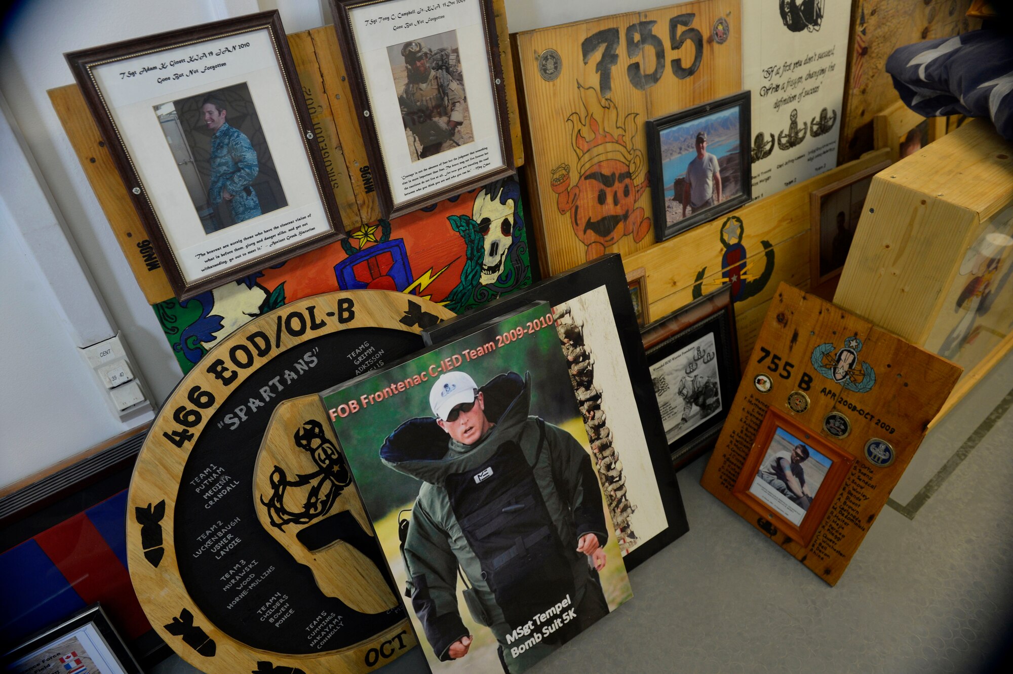 Plaques from the 466th Operating Location Bravo Explosive Ordnance Disposal flight are prepared for packing at Kandahar Airfield, Afghanistan Aug. 18, 2014.  The unit completed their last mission in Afghanistan Aug. 19, 2014. In the last ten years of the unit’s existence eight EOD members have lost their lives.  (U.S. Air Force photo by Staff Sgt. Evelyn Chavez/Released)
