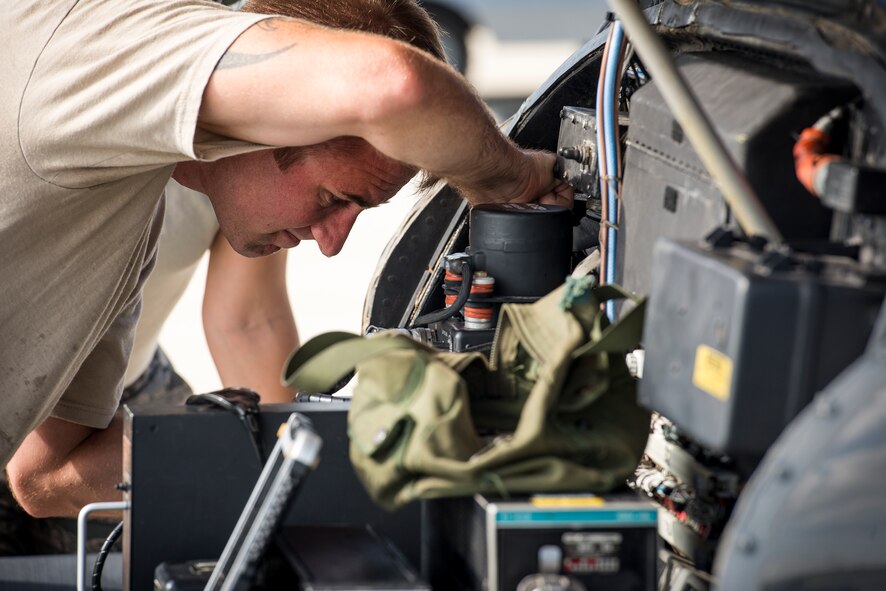 U.S. Air Force Staff Sgt. Christopher Scott, 23d Maintenance Group instrument flight control systems craftsman, replaces a turn-rate gyroscope on an HH-60G Pave Hawk at Moody Air Force Base, Ga., Aug. 19, 2014. The gyroscope provides real-time flight information to pilots. (U.S. Air Force photo by Airman 1st Class Ryan Callaghan/Released)