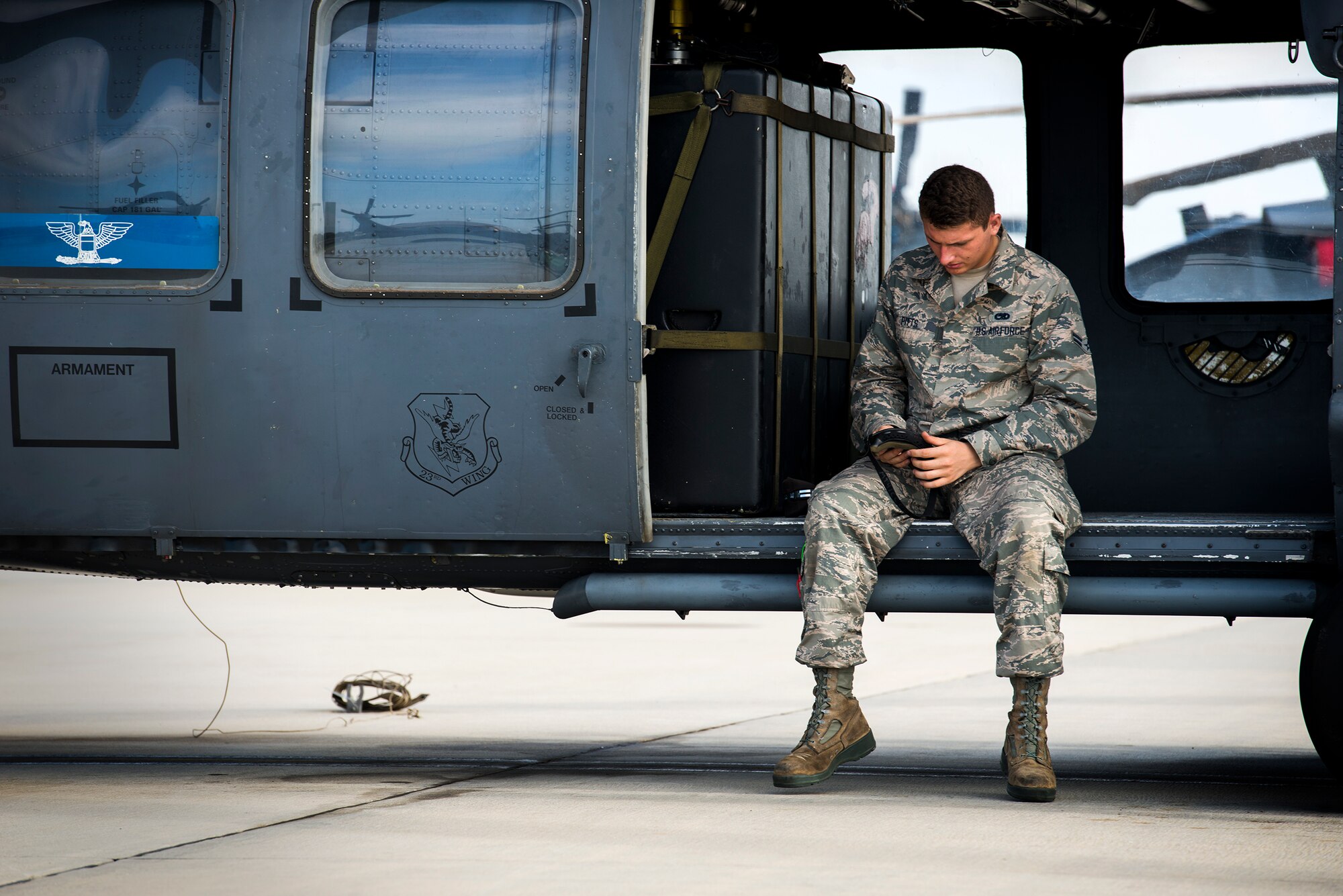 U.S. Air Force Airman 1st Class Carlos Pitts Jr., 723d Aircraft Maintenance Squadron aerospace propulsion apprentice, readies his eye protection on an HH-60G Pave Hawk at Moody Air Force Base, Ga., Aug. 19, 2014. Pitts is becoming dual-qualified as a crew chief, allowing him to perform pre- and post-flight inspections as well as marshal the aircraft to the runway. (U.S. Air Force photo by Airman 1st Class Ryan Callaghan/Released)