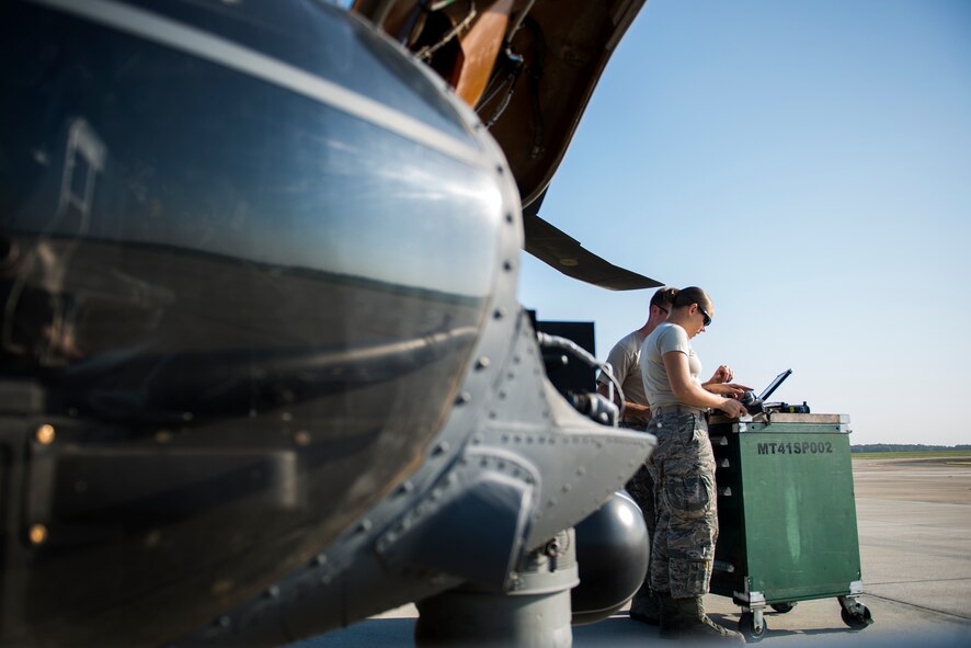 Airmen from the 41st Helicopter Maintenance Squadron review technical orders (TO) before beginning work on an HH-60G Pave Hawk at Moody Air Force Base, Ga., Aug. 19, 2014. Prior to performing any maintenance on an aircraft, Airmen review a checklists, known as TOs, to ensure the work is done properly and consistently. (U.S. Air Force photo by Airman 1st Class Ryan Callaghan/Released)