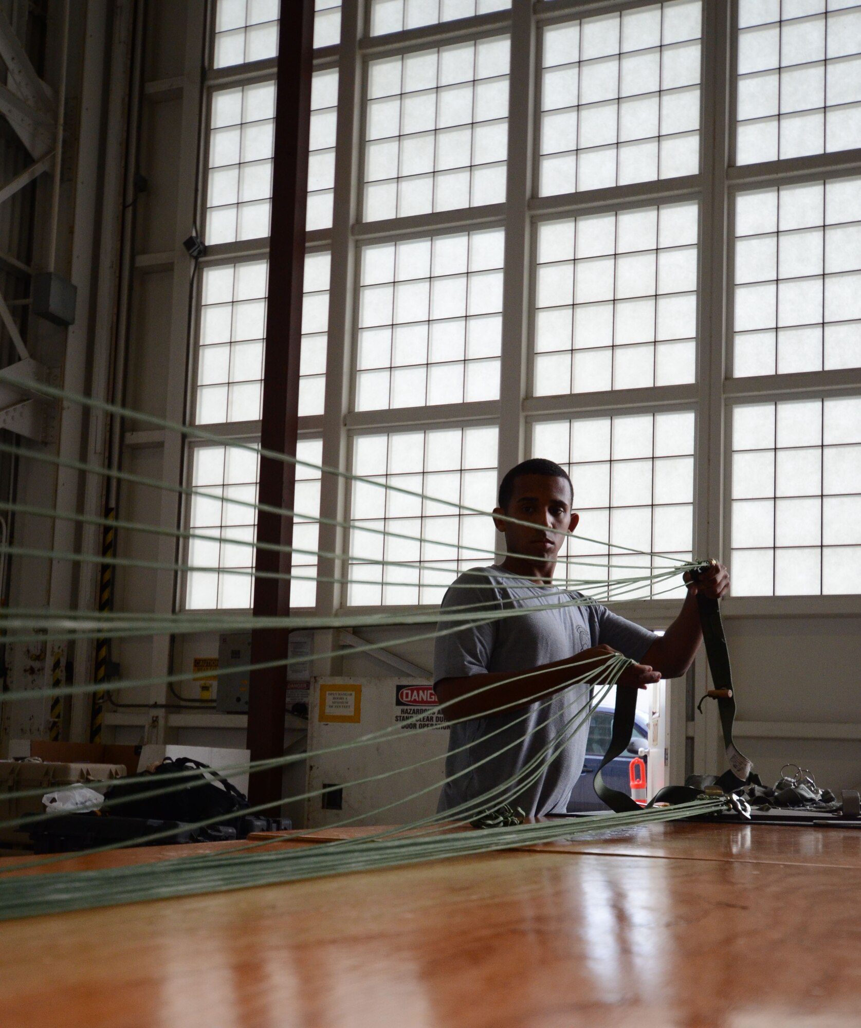 Senior Airman Felipe Gulifu, an aircrew flight equipment Airman for the 308th Rescue Squadron, packs a parachute, August 15, 2014, at Patrick Air Force Base, Fla. Reserve AFE specialists from the 308 RQS, pack, maintain and inspect parachutes and package cargo to be dropped from aircraft. (U.S. Air Force photo/ Tech. Sgt. Katie Spencer) 