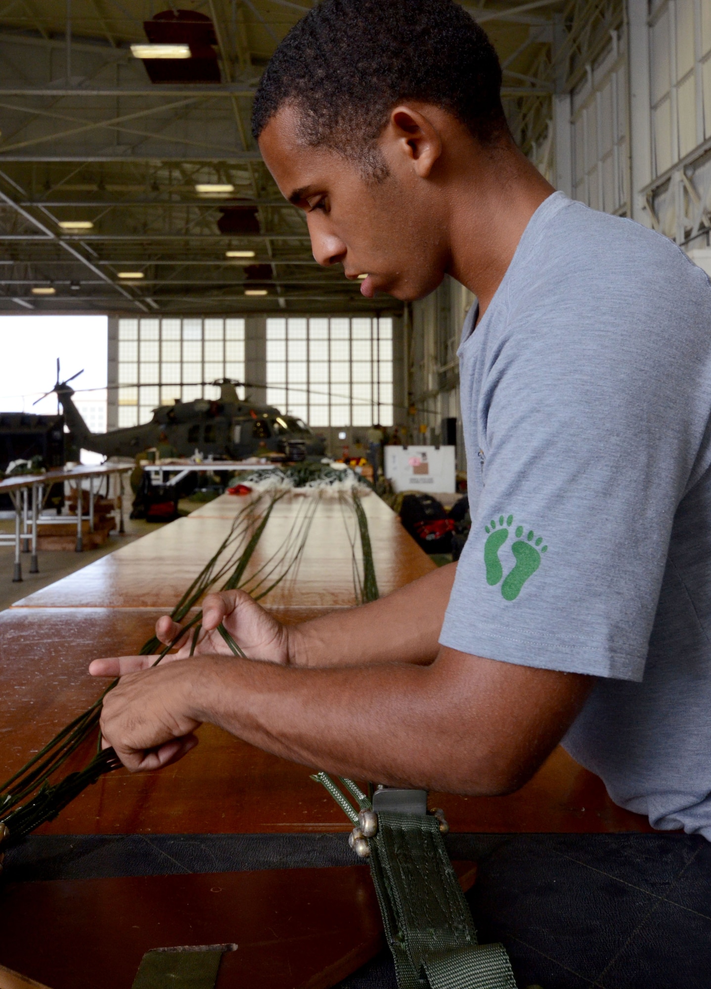 Senior Airman Felipe Gulifu, an aircrew flight equipment Airman for the 308th Rescue Squadron, packs a parachute, August 15, 2014, at Patrick Air Force Base, Fla. Reserve AFE specialists from the 308 RQS, pack, maintain and inspect parachutes and package cargo to be dropped from aircraft. (U.S. Air Force photo/ Tech. Sgt. Katie Spencer) 