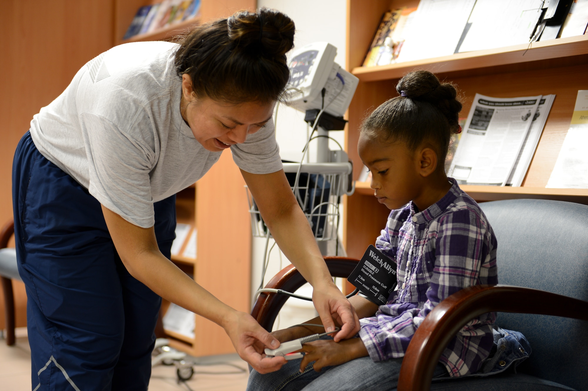 Capt. Richelle Bornales, 86th Contingency Aeromedical Staging Facility clinical nurse, checks the blood pressure of a Tori Liggins during Sports Physical Day hosted by the 86th Medical Group on Ramstein Air Base, Germany, Aug. 16, 2014. In an eight-hour period, the medical group conducted eye screening tests, checked blood pressure, measured temperature and performed basic physicals for 440 patients in the Kaiserslautern Military Community. (U.S. Air Force photo/Airman 1st Class Michael Stuart)