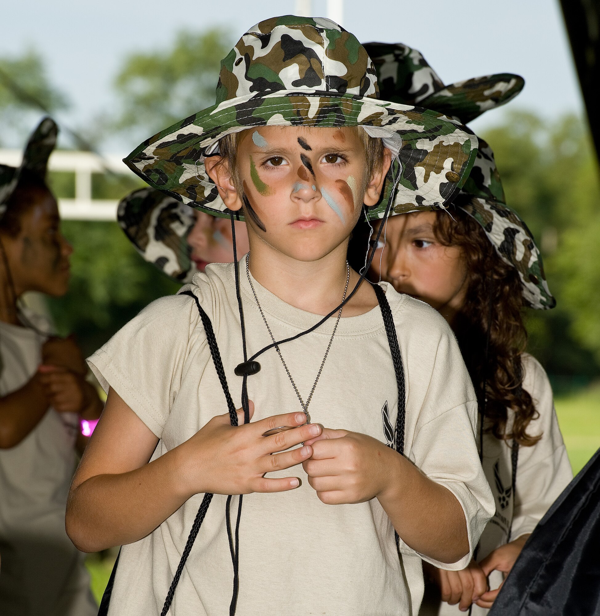Jackson Rudderforth, son of Tech. Sgt. Paige Mallory, 736th Aircraft Maintenance Squadron, waits in a simulated deployment processing line Aug. 20, 2014, at the Youth Center on Dover Air Force Base, Del. KUDOS, Kids Understanding Deployment Operations allowed 161 children and 83 teachers to go through a simulated deployment processing line and numerous obstacle courses to experience what military members go through. (U.S. Air Force photo/Roland Balik)