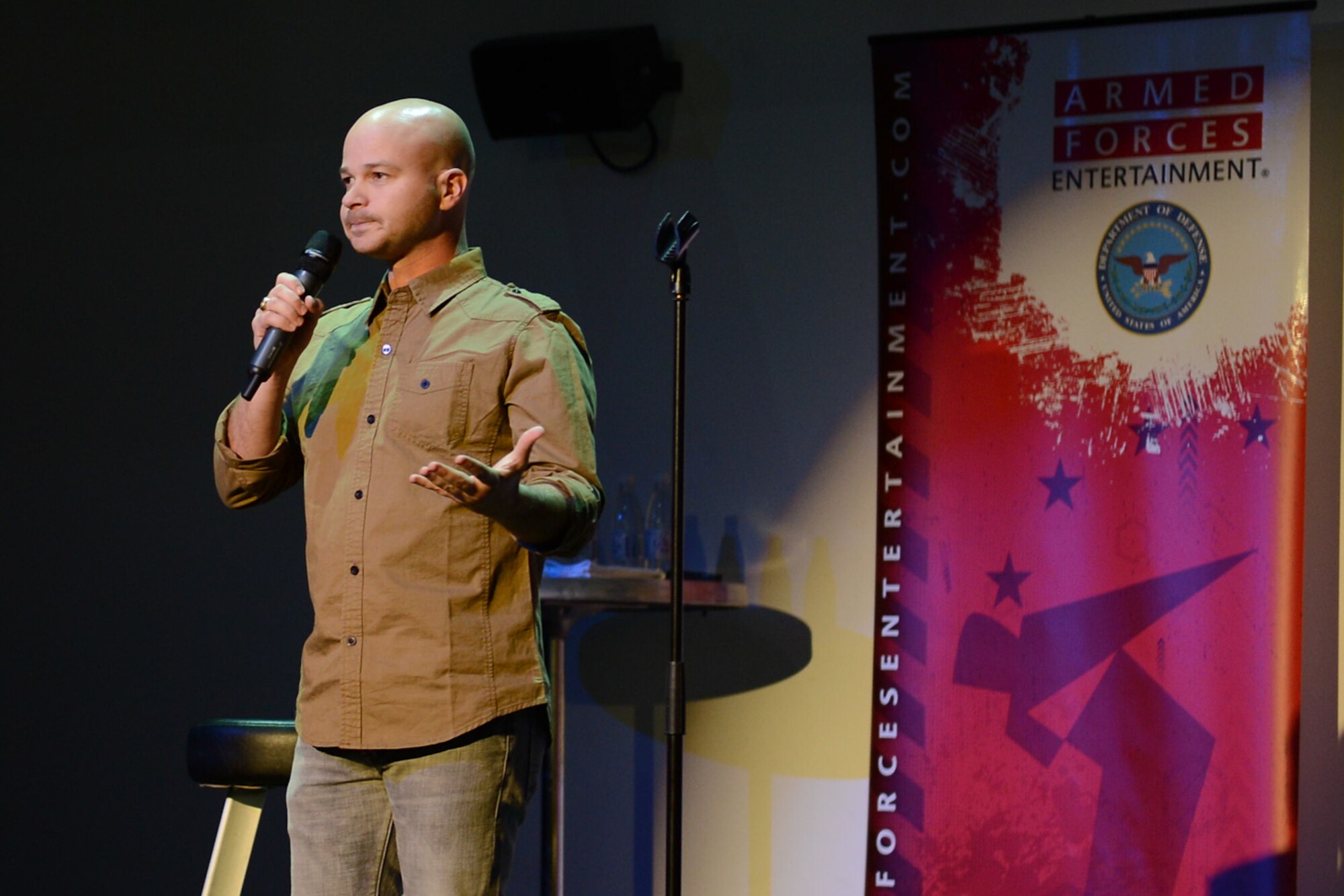 Army Reserve Master Sgt., Benari Poulten, performs on stage during the GIs of Comedy show at the Enlisted Club on Ramstein Air Base, Germany, Aug. 18, 2014. The comedy show was a free, 90-minute performance sponsored by Armed Forces Entertainment and is only a small fraction of a 30-day tour around Europe and the Mediterranean for the comedic group. (U.S. Air Force photo/Airman 1st Class Michael Stuart) 
