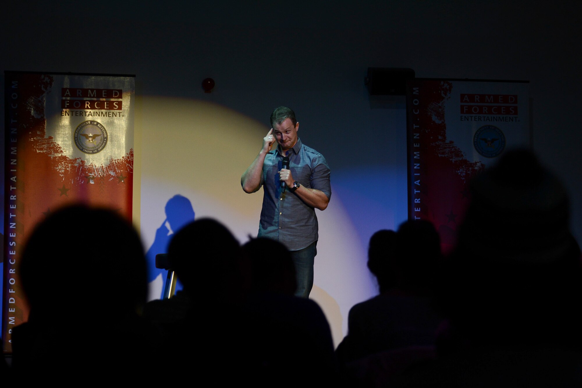 Patrick “PJ” Walsh, retired Navy, performs on stage during the GIs of Comedy show at the Enlisted Club on Ramstein Air Base, Germany, Aug. 18, 2014. The GIs of Comedy are a group of four stand-up comedians, all combat veterans, who go on tour entertaining service members around the world. (U.S. Air Force photo/Airman 1st Class Michael Stuart) 
