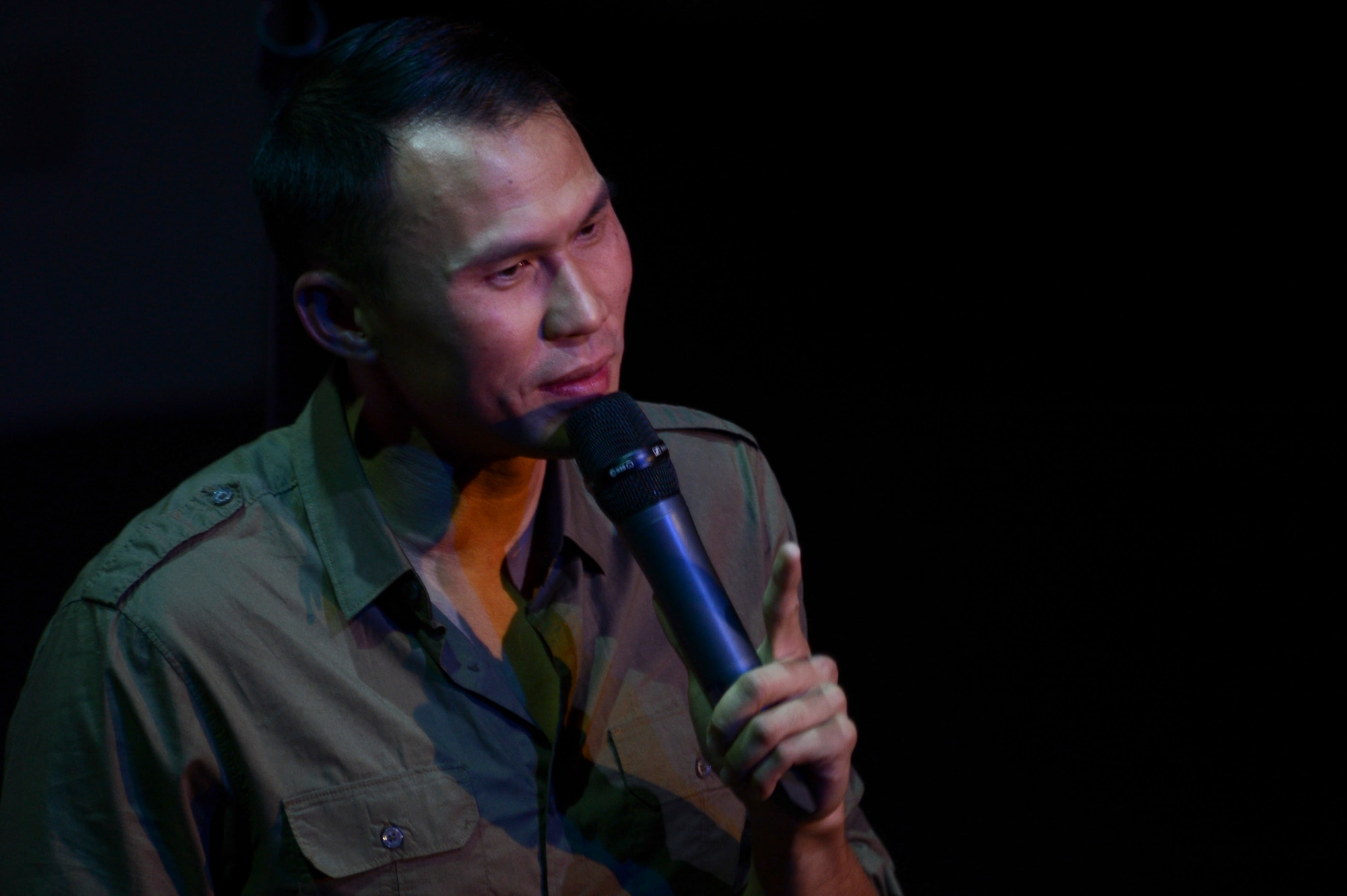 Thom Tran, retired Army staff sergeant, performs on stage during the GIs of Comedy show at the Enlisted Club on Ramstein Air Base, Germany, Aug. 18, 2014. The comedy show was a free, 90-minute performance sponsored by Armed Forces Entertainment to boost the morale and entertain service members in the Kaiserslautern Military Community. (U.S. Air Force photo/Airman 1st Class Michael Stuart) 