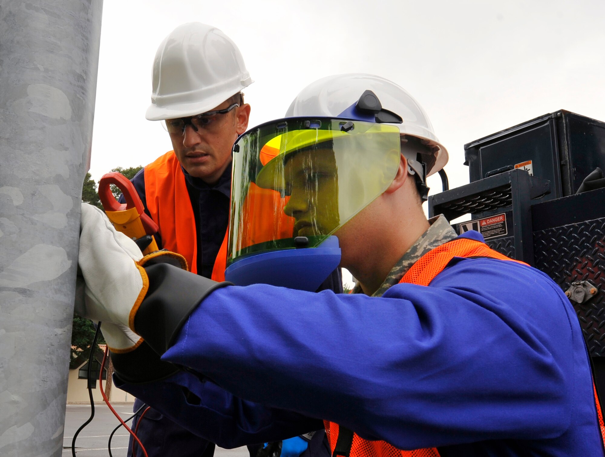 Airman 1st Class Keith Martineau, 786th Civil Engineer Squadron electrical systems journeyman, and Tech. Sgt. Jason Howland, 786th CES NCO in charge of exterior electrical systems, check the circuit in a streetlight before repairing it Aug. 15, 2014 at Ramstein Air Base, Germany. The night operations crew repaired and replaced more than 500 lights during their three week effort. (U.S. Air Force photo/Airman Larissa Greatwood)