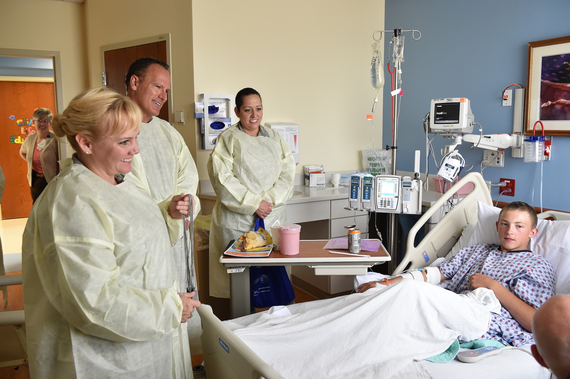 Tech. Sgt. Kalee Lint, administrative assistant to the command chief, Col. Darryl Markowski, 910th Airlift Wing vice commander, and Master Sgt. Kelly Turner, Wing career advisor, talk with 14-year-old Tyler at Akron Children’s Hospital Boardman, Aug. 20. Several 910th Airmen visited patients at the hospital to support Youngstown Air Reserve Station’s community outreach program and spread some cheer. U.S. Air Force photo/Eric M. White