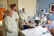 Tech. Sgt. Kalee Lint, administrative assistant to the command chief, Col. Darryl Markowski, 910th Airlift Wing vice commander, and Master Sgt. Kelly Turner, Wing career advisor, talk with 14-year-old Tyler at Akron Children’s Hospital Boardman, Aug. 20. Several 910th Airmen visited patients at the hospital to support Youngstown Air Reserve Station’s community outreach program and spread some cheer. U.S. Air Force photo/Eric M. White