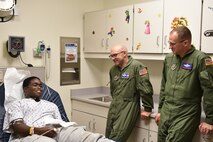 Lt. Col. John “Chinky” Kochansky, assistant deputy officer of the 757th Airlift Squadron, and Lt. Col. Chris Zwetzig, 910th Operations Group standards evaluation navigator, talk to 18-year-old Erin at Akron Children’s Hospital Boardman, Aug. 20. Several 910th Airmen visited patients at the hospital to support Youngstown Air Reserve Station’s community outreach program and spread some cheer. U.S. Air Force photo/Eric M. White