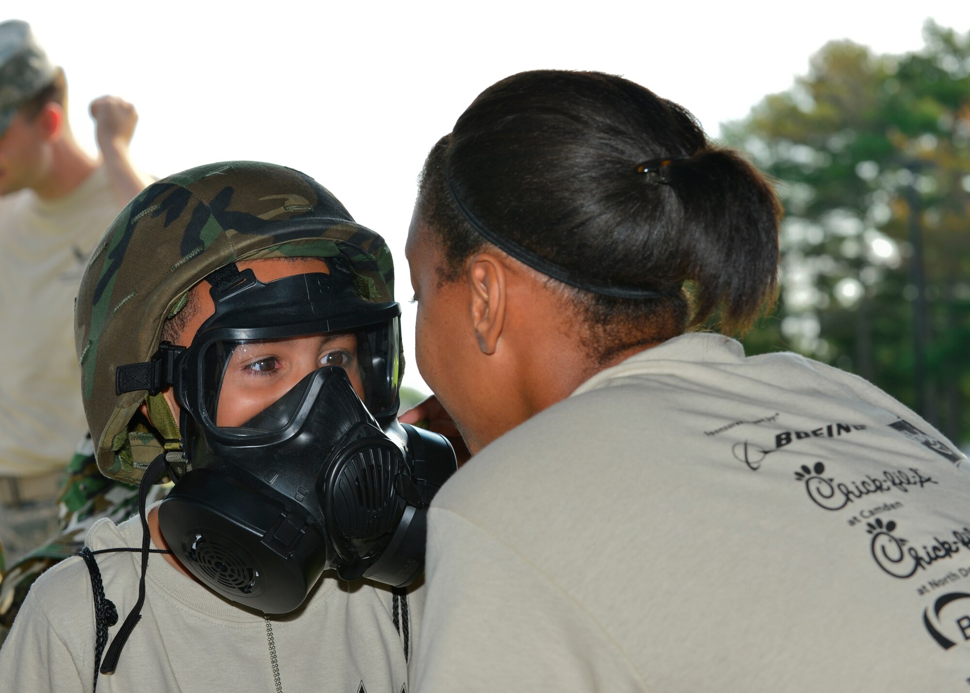 Tristin Walton, son of Staff Sgt. Derek Walton, 436th Logistics Readiness Squadron, wears a chemical mask during Operation KUDOS, Kids Understanding Deployment Operations Aug. 20, 2014, at the Youth Center on Dover Air Force Base, Del. Children went through a deployment process line and participated in deployed activities and exercises to give them a better perception of what their parents do when preparing for a deployment. (U.S. Air Force photo/Airman 1st Class William Johnson)